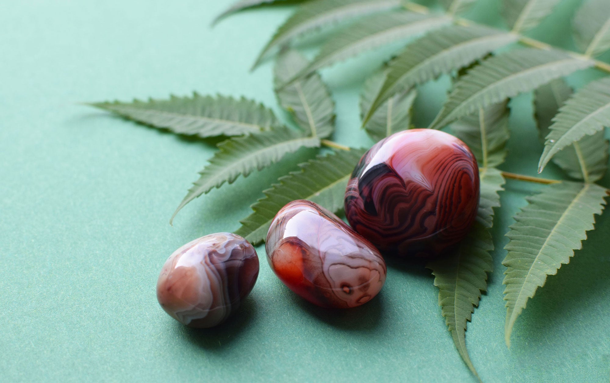 An agate stone with swirling patterns in shades of blue, white and gray displaying its unique banding and natural beauty