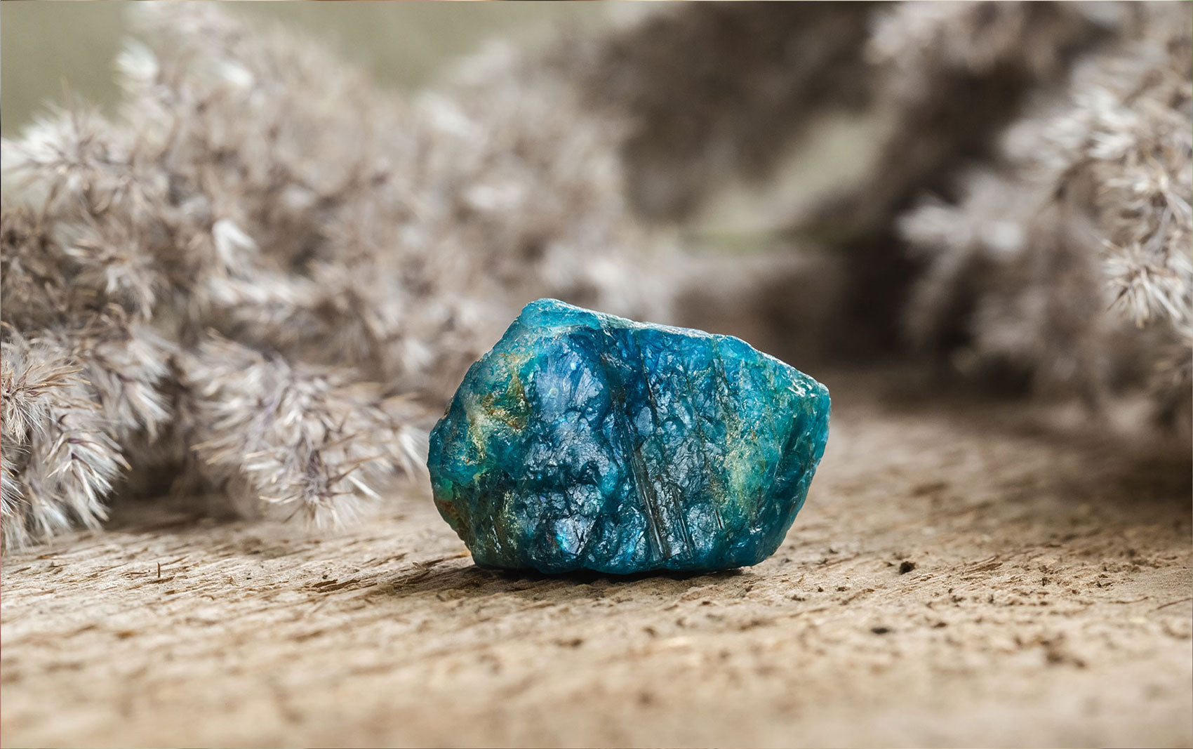 A vibrant blue Apatite gemstone with a smooth polished surface and rich