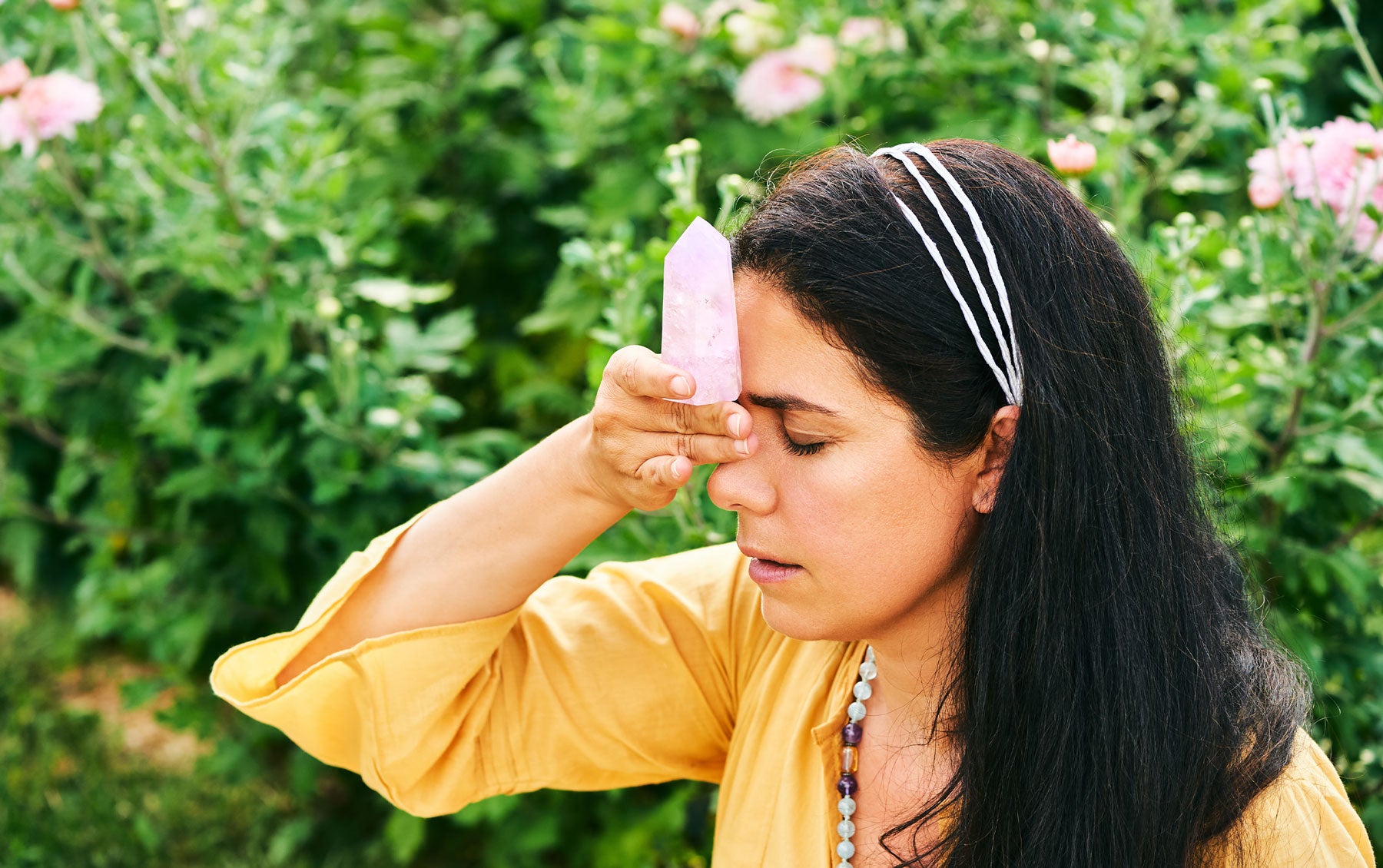 A pale pink Kunzite gemstone with a delicate transparent appearance and faceted cut