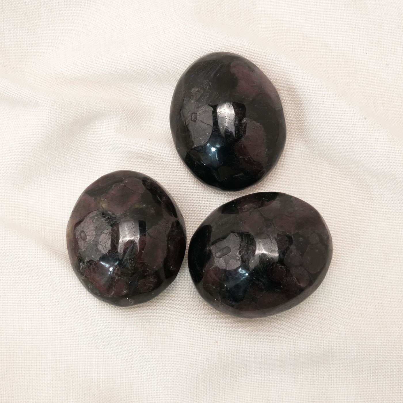 Handheld Garnet Palm Stone used for boosting physical and emotional energy