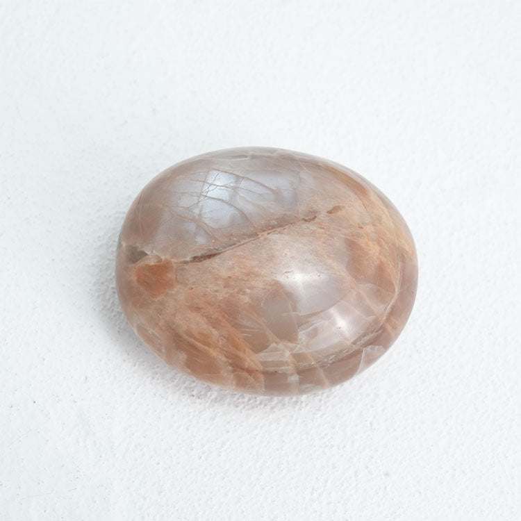 Orange Moonstone Palm Stone, ideal for promoting creativity and inspiration