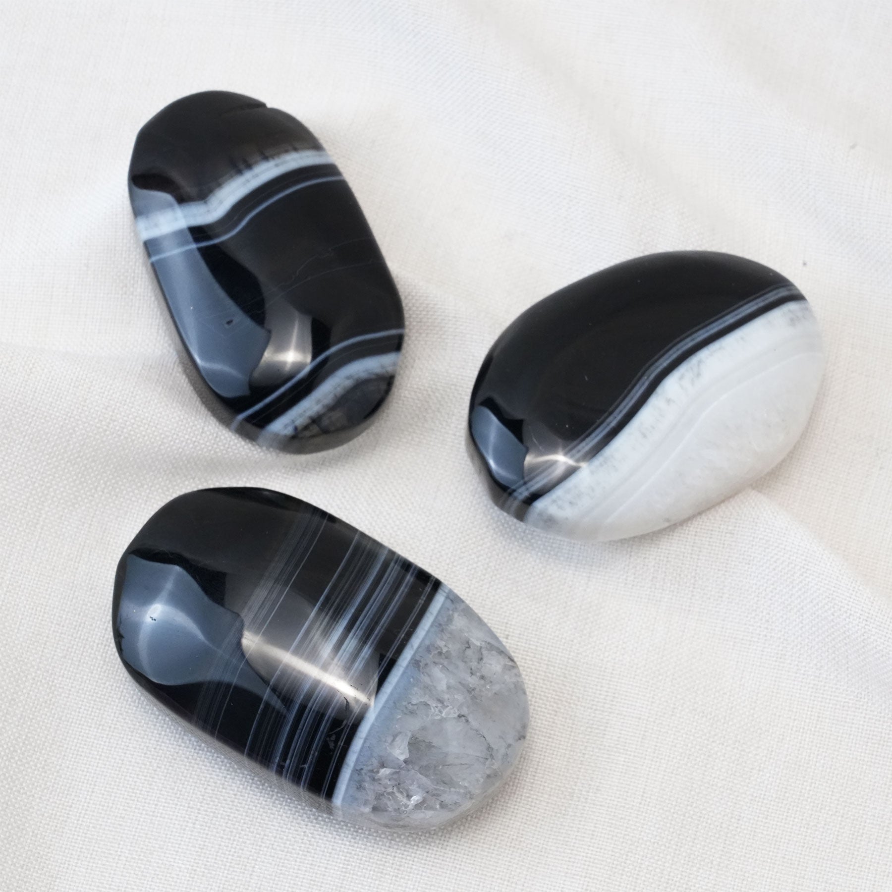 The grounding energy of the Black Lace Agate Palm Stone helps to improve focus and mental clarity