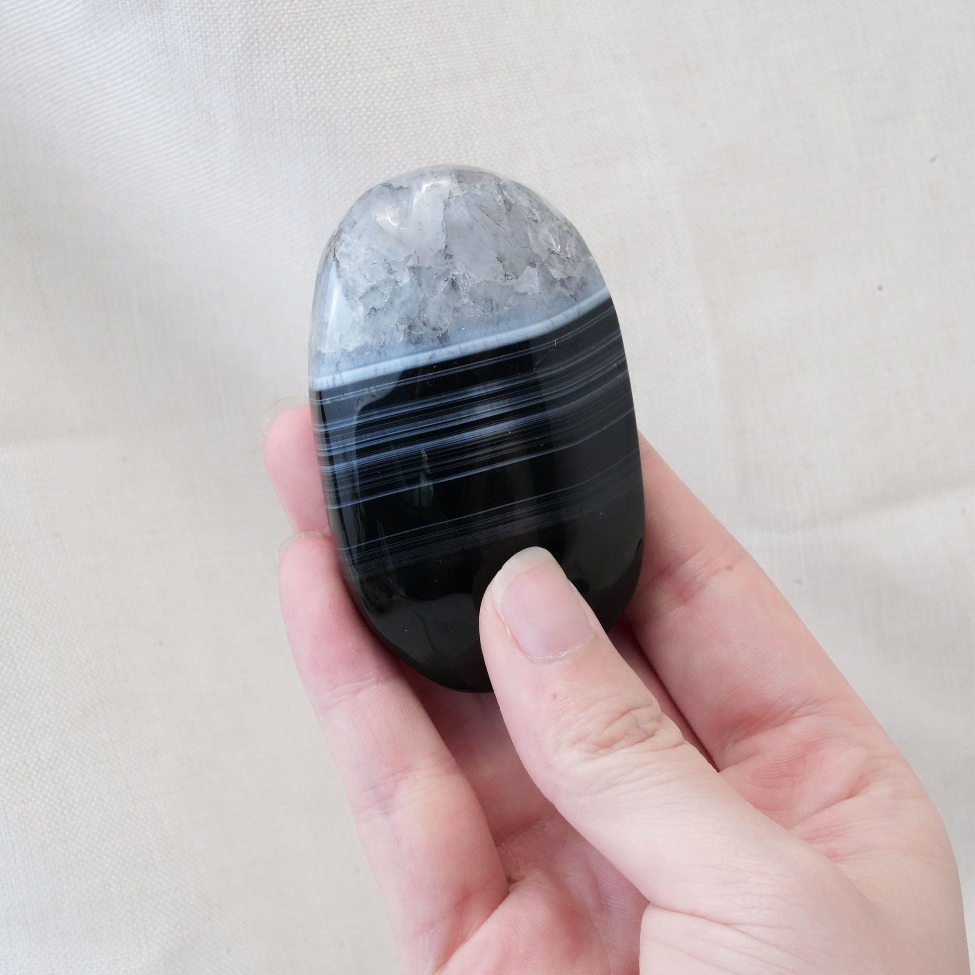The Black Lace Agate Palm Stone is celebrated for its ability to reduce stress and provide protection from negative energies