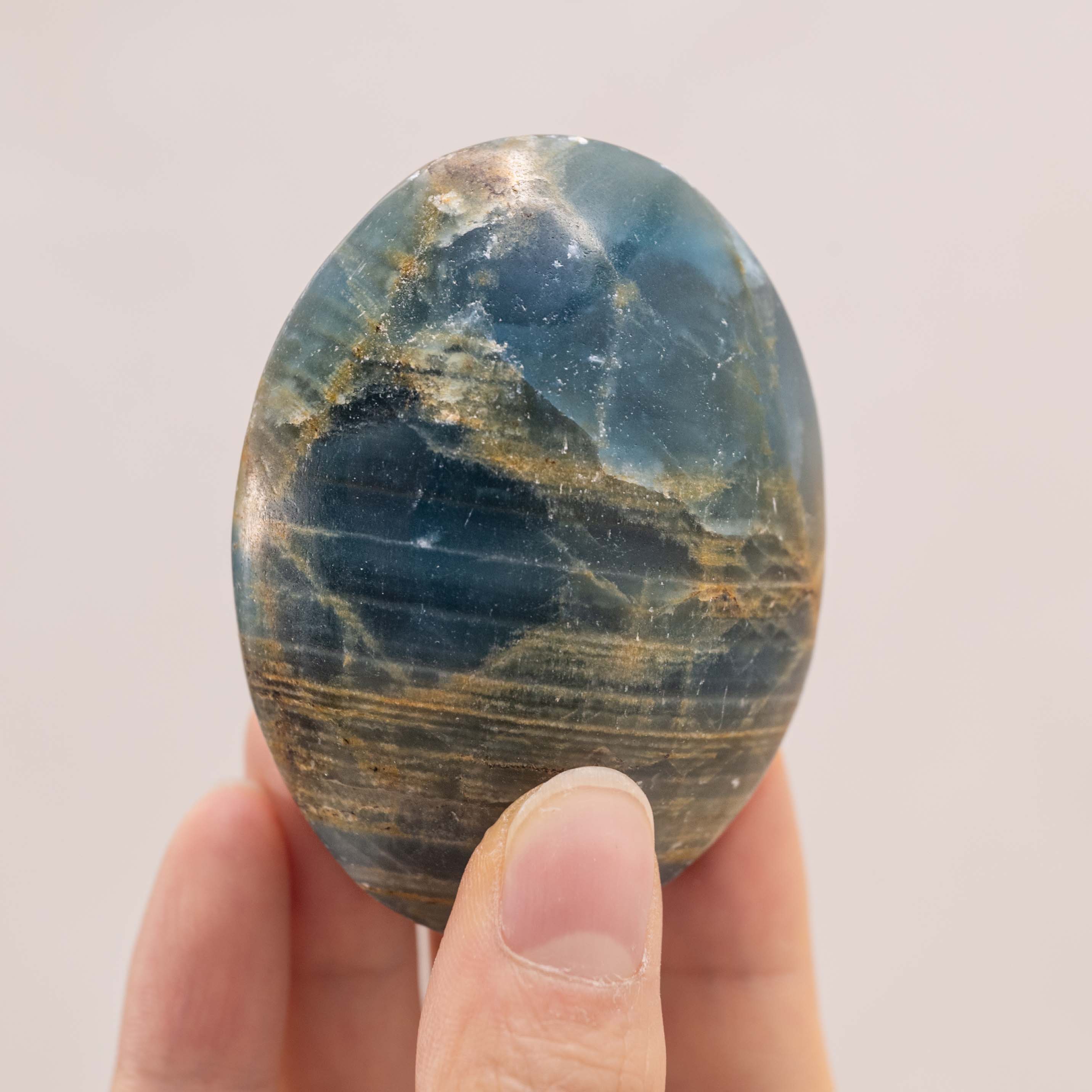 Hand-polished Blue Onyx Palm Stone, perfect for enhancing tranquility