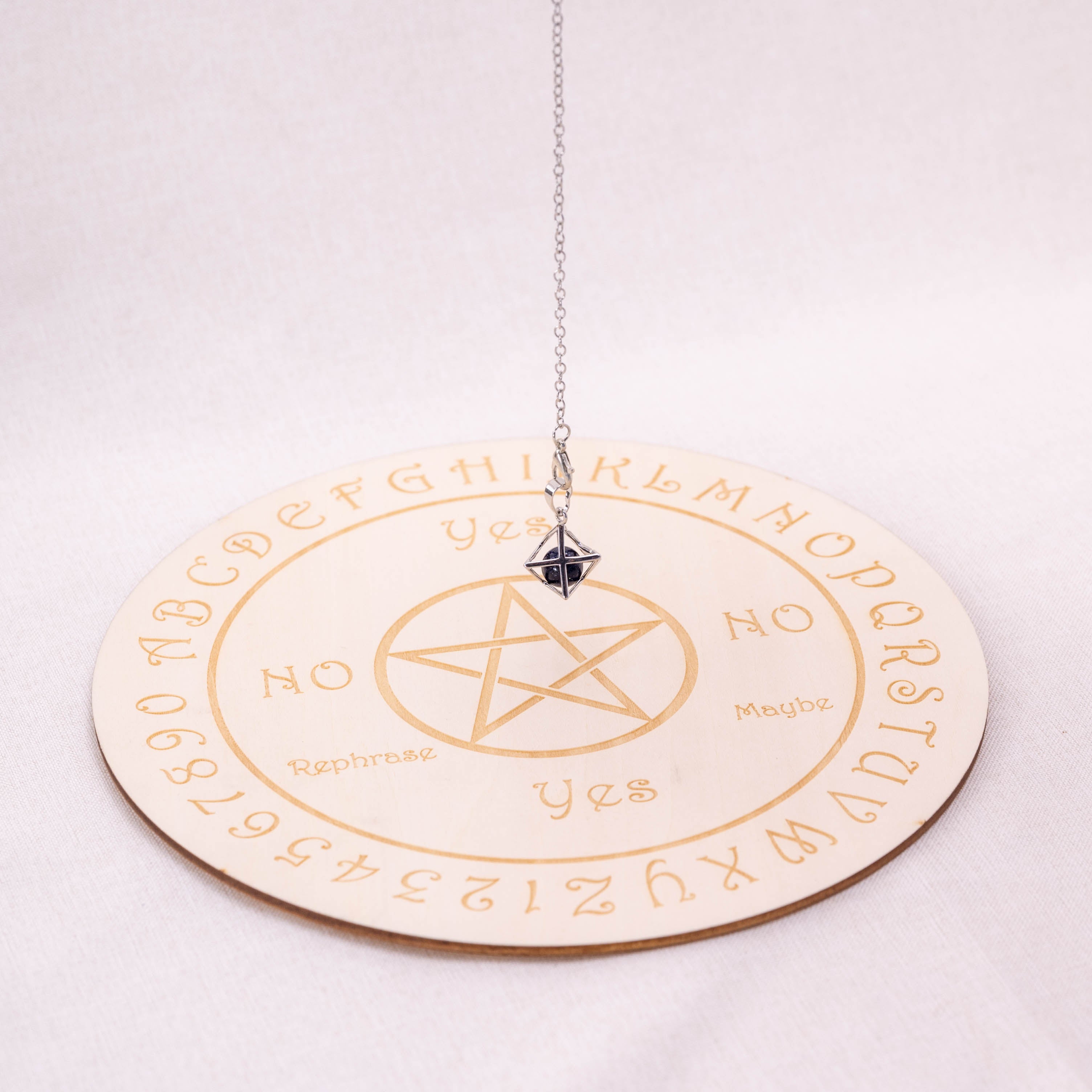 Detailed view of Blue Sand Stone Merkaba-shaped pendulum