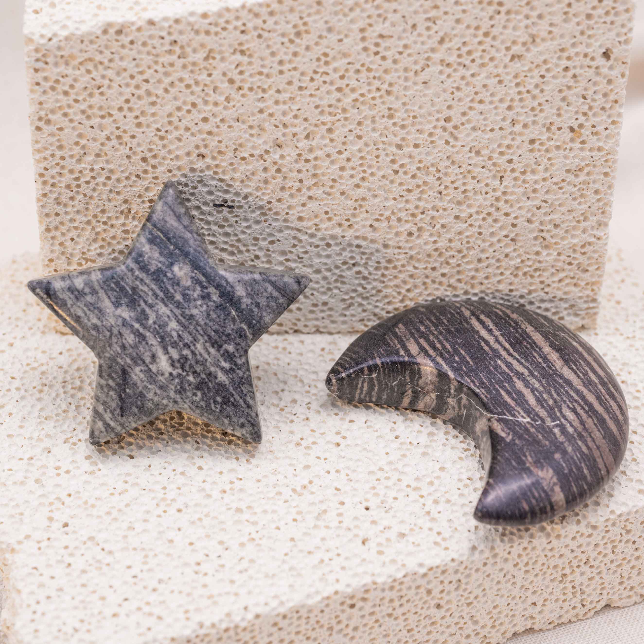 Display of Black Net Stone Star/Moon Palm Stone