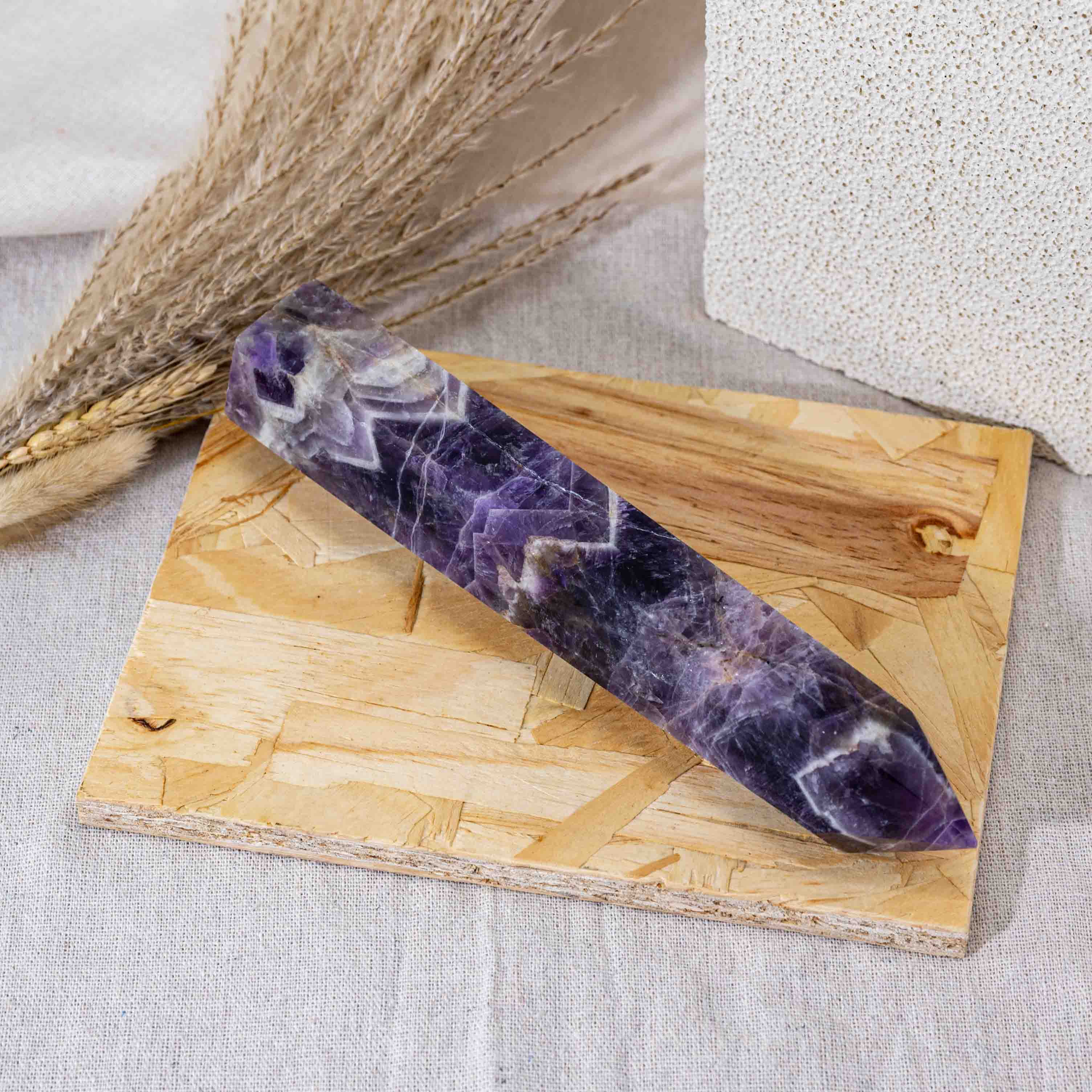 Handcrafted from natural Dream Amethyst, this tower enhances intuition and emotional balance, making it an essential addition to any crystal collection