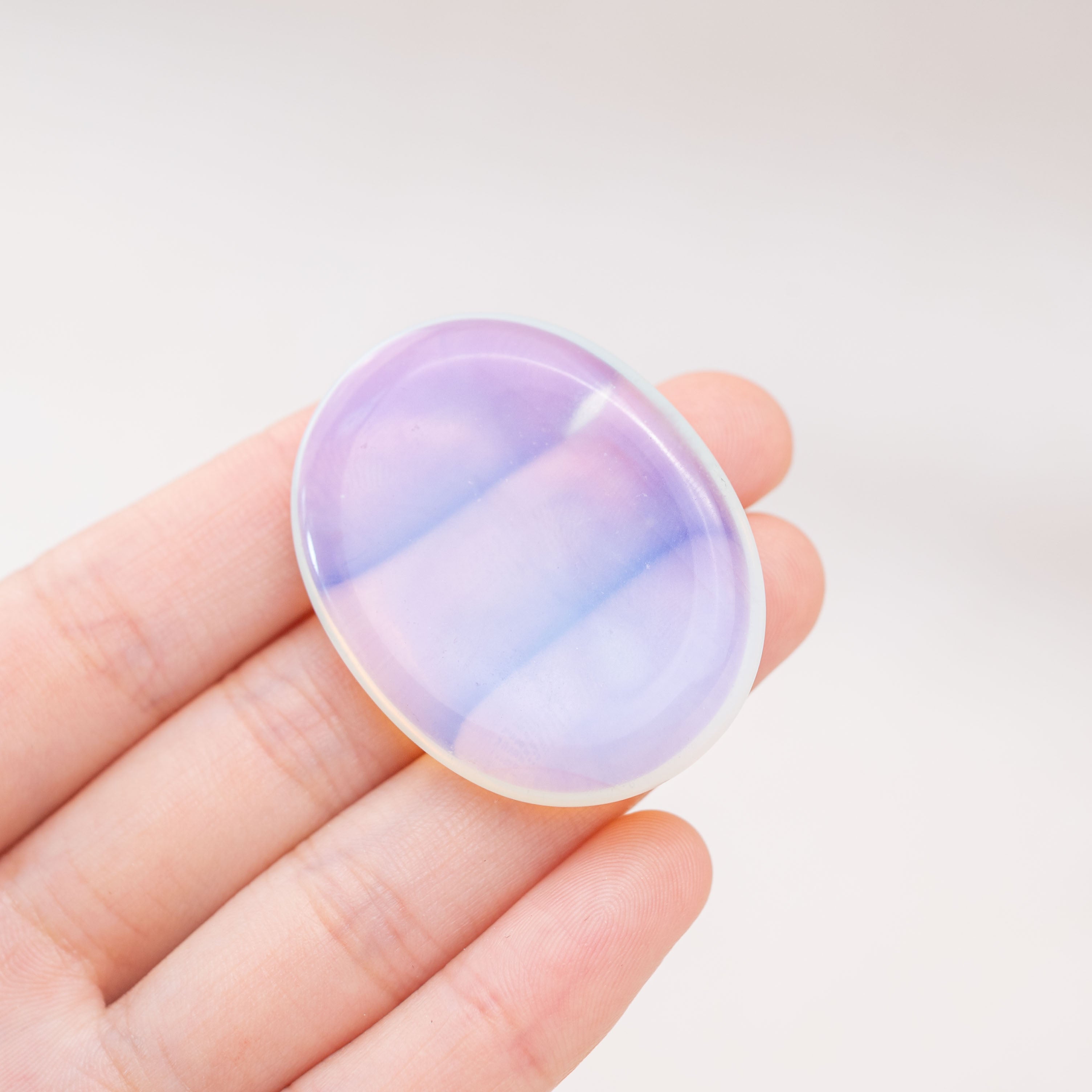 The Opalite Worry Stone symbolizes new beginnings and transformation
