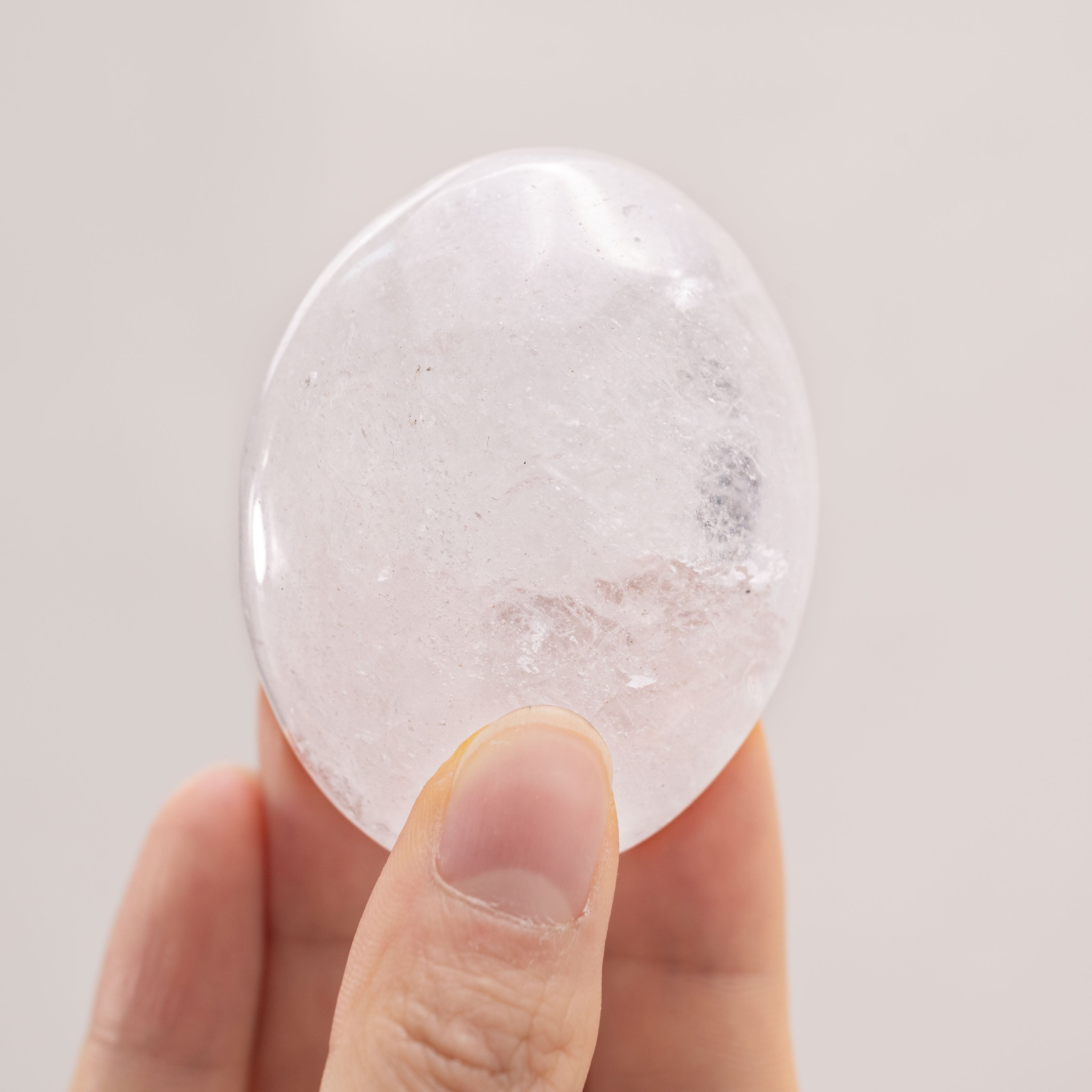 Clear Quartz Palm Stone with vibrant clarity and unique formations