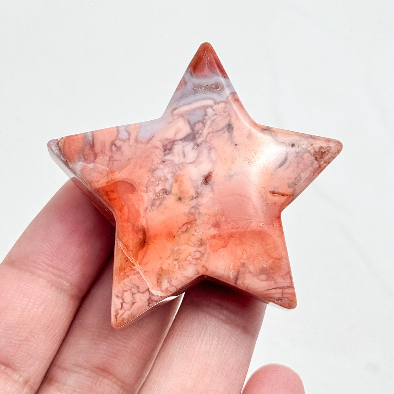 Person Holding a Petal Agate Star/Moon Palm Stone for Meditation