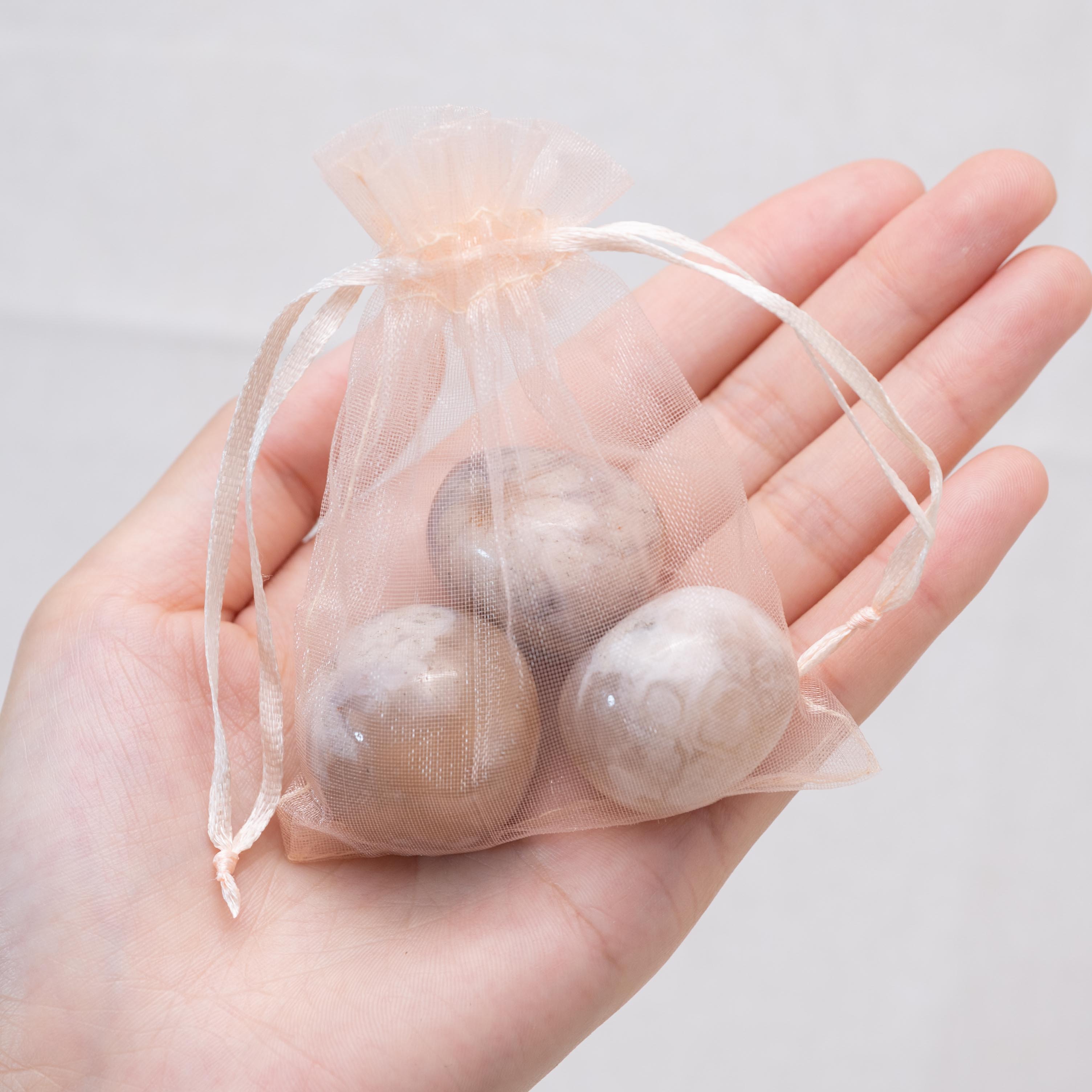 Detail shot of Flower Agate tumbled stone's unique patterns