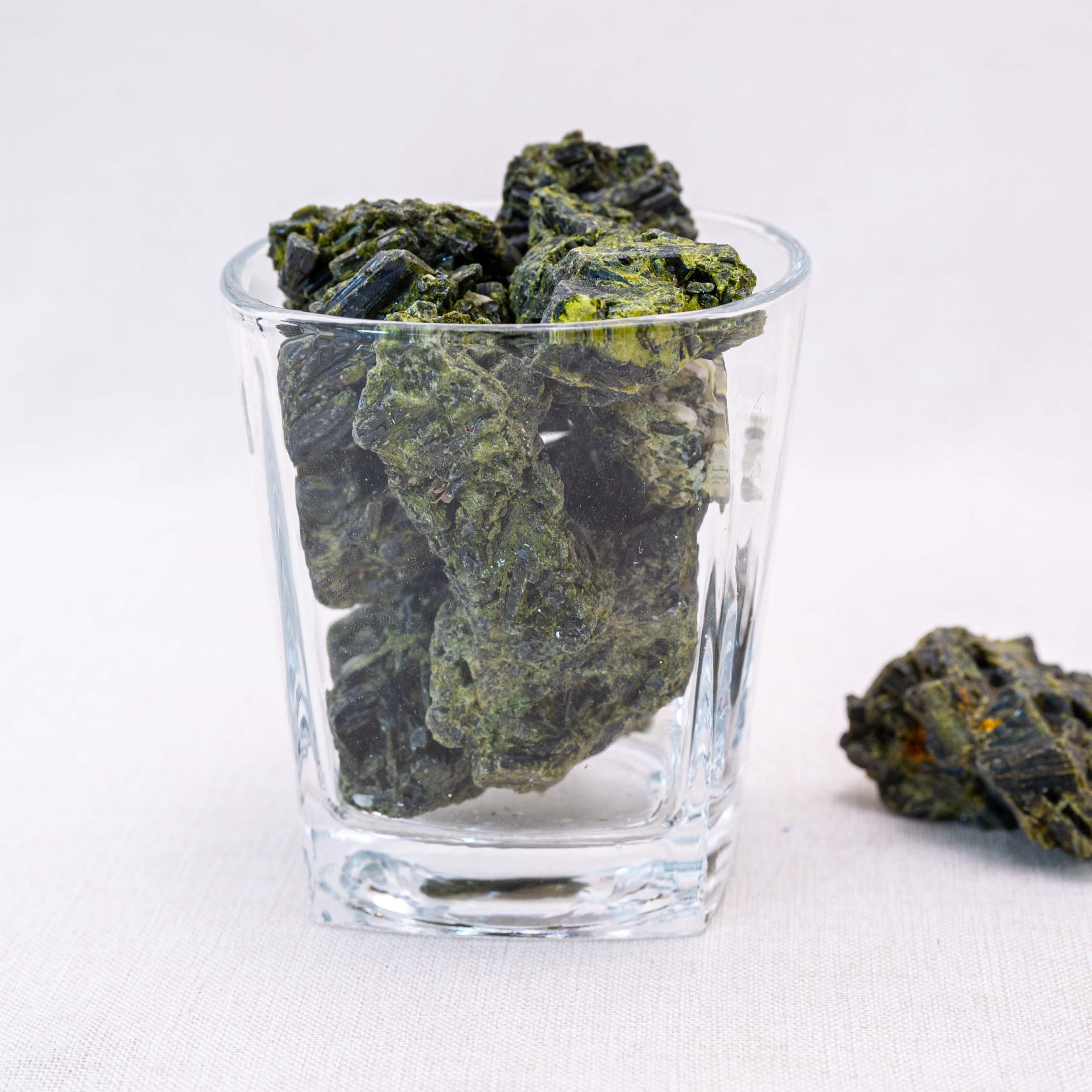 Unpolished green tourmaline stones promote abundance