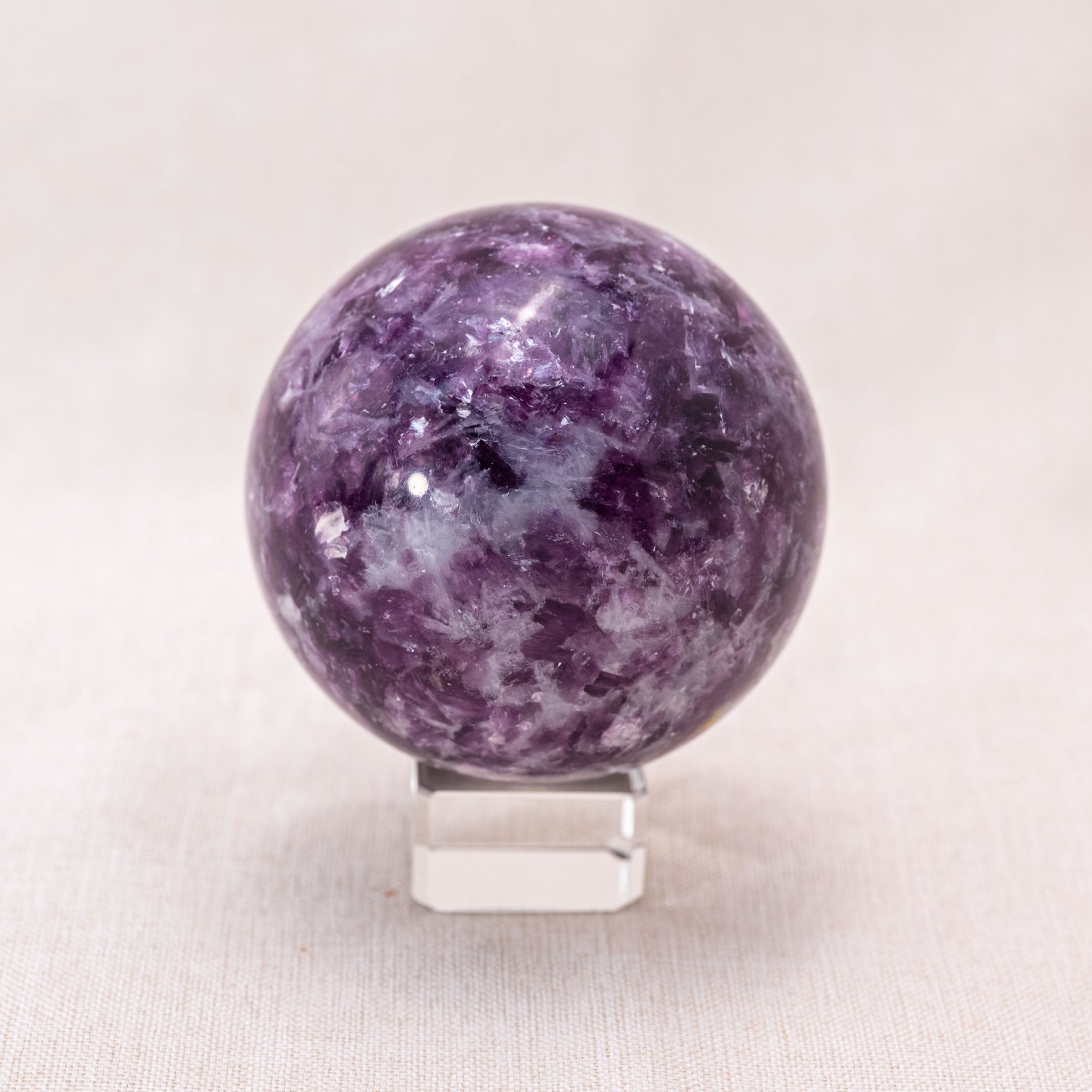 The Lepidolite Sphere promotes emotional balance.