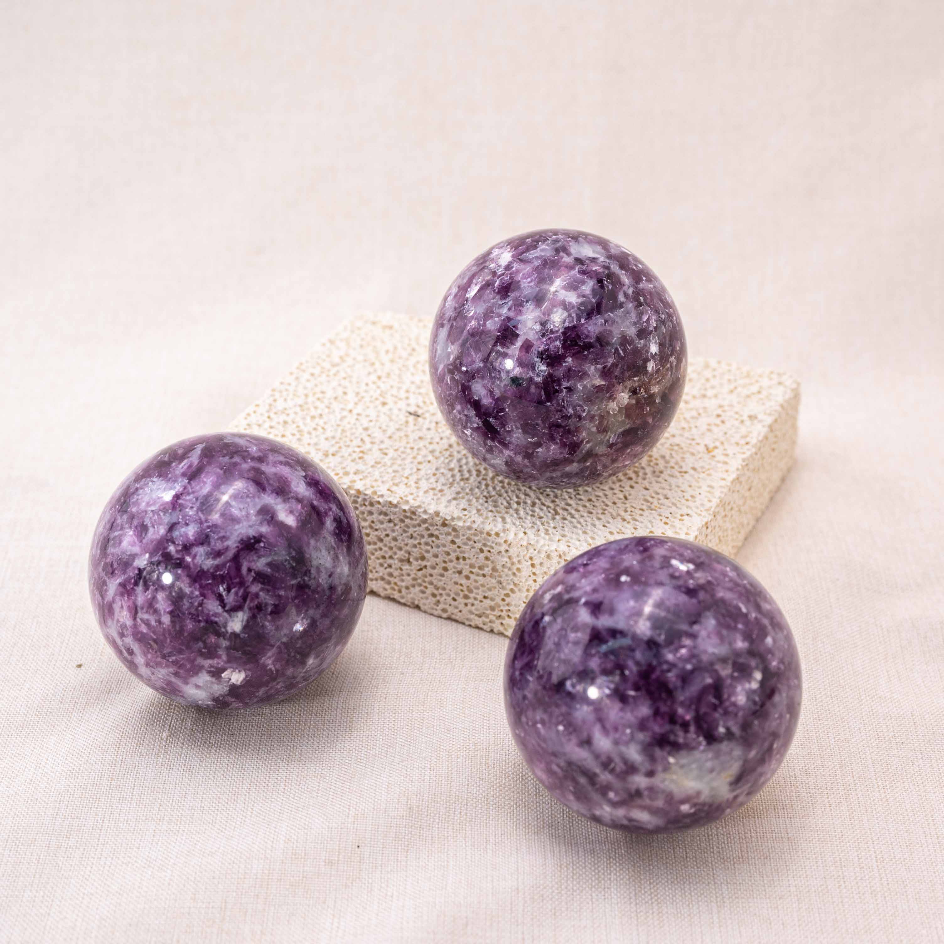 The Lepidolite Sphere emits calming energy.