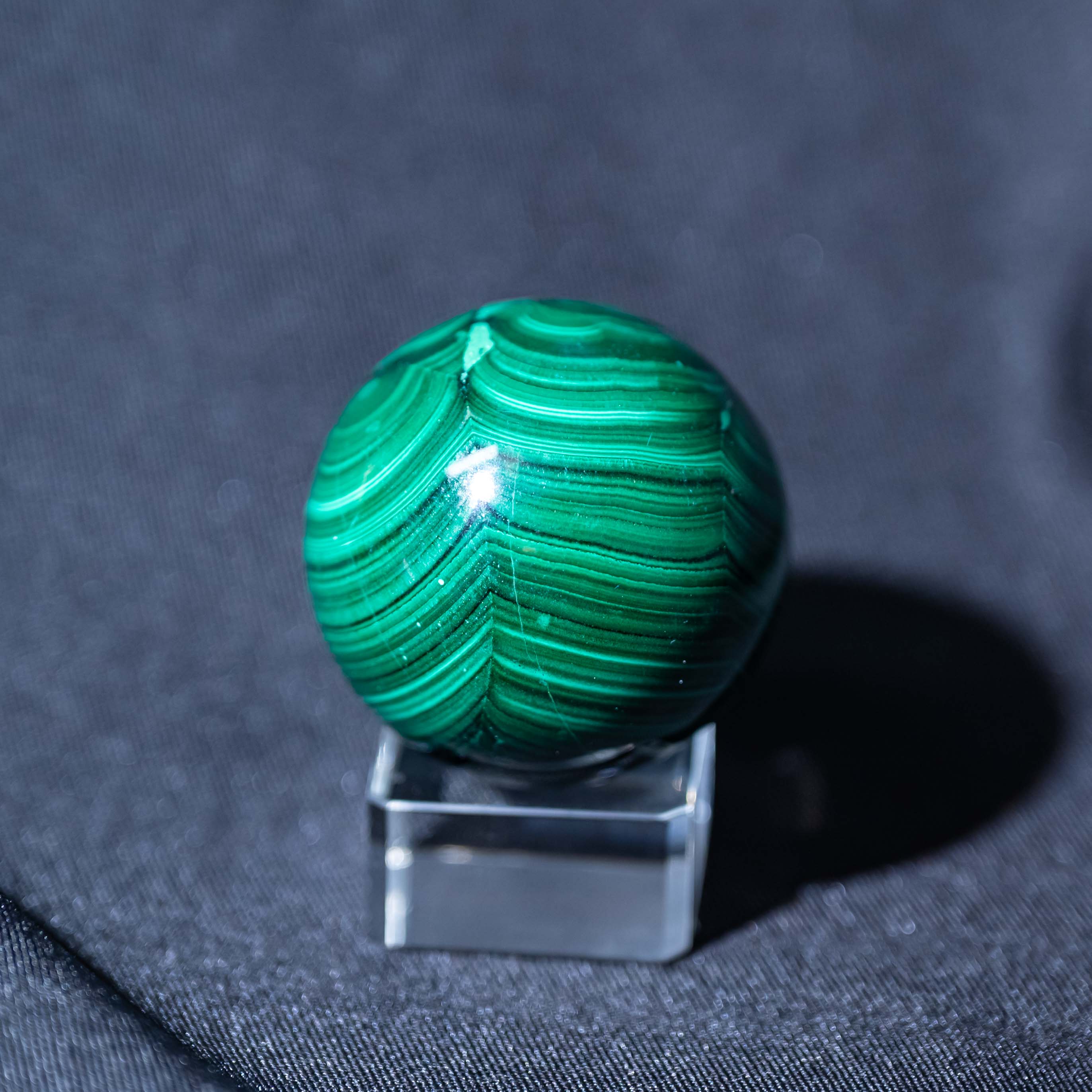 Hand-polished Malachite Sphere for enhancing spiritual growth and inner peace.