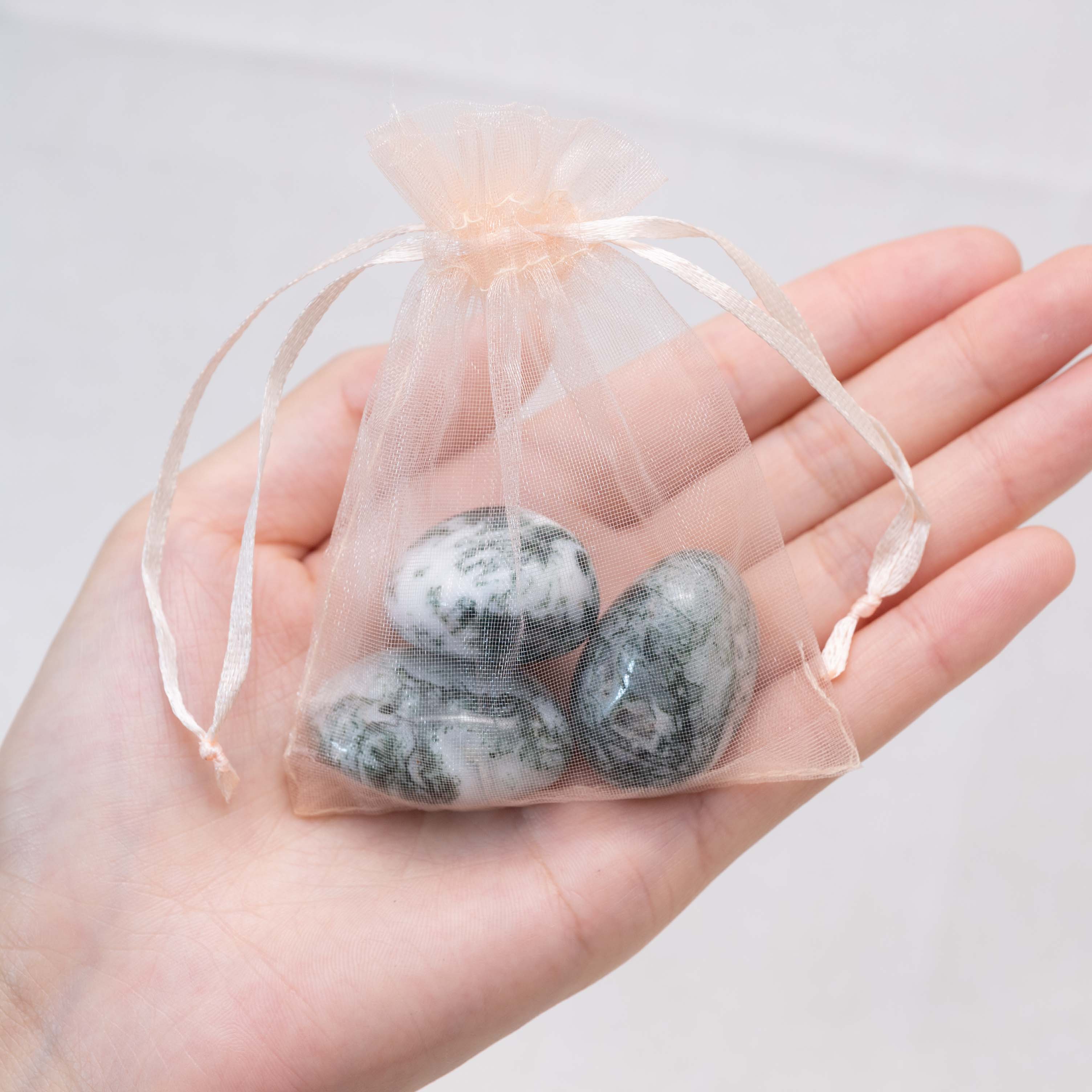 Detail shot of Moss Agate tumbled stone's earthy tones