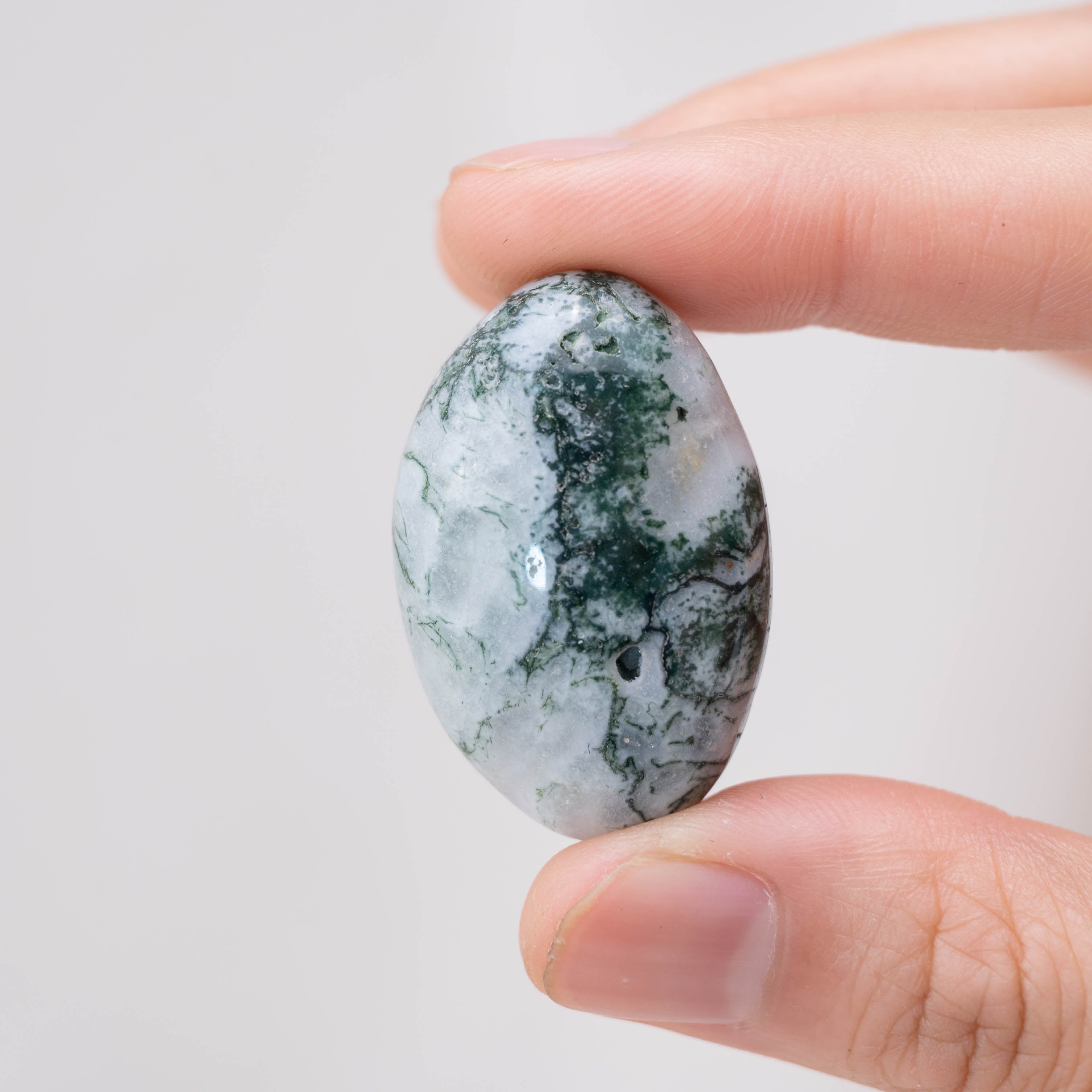 Laid-out Moss Agate tumbled stones for harmony and balance