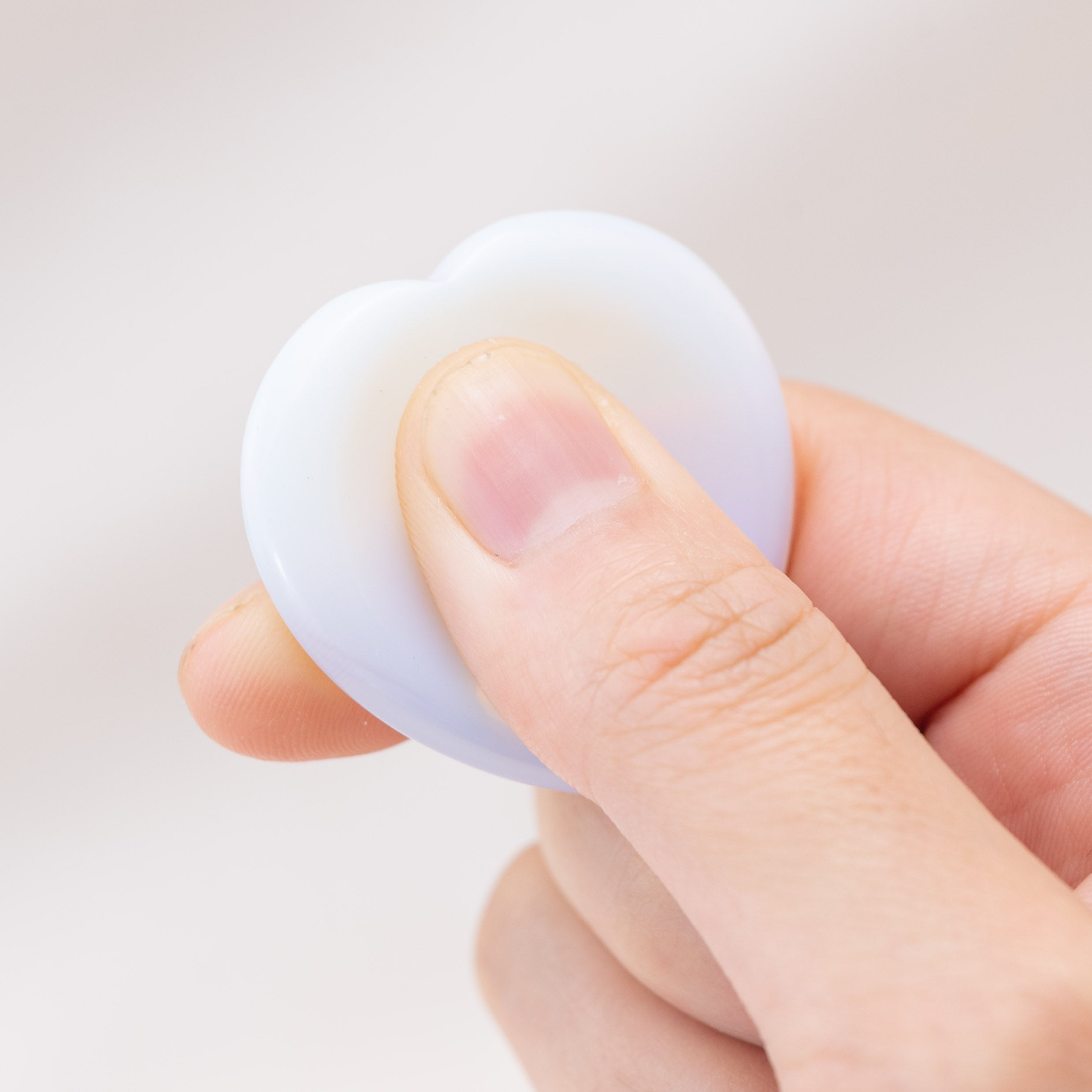Carry the Opalite Heart Worry Stone to boost confidence and communication skills