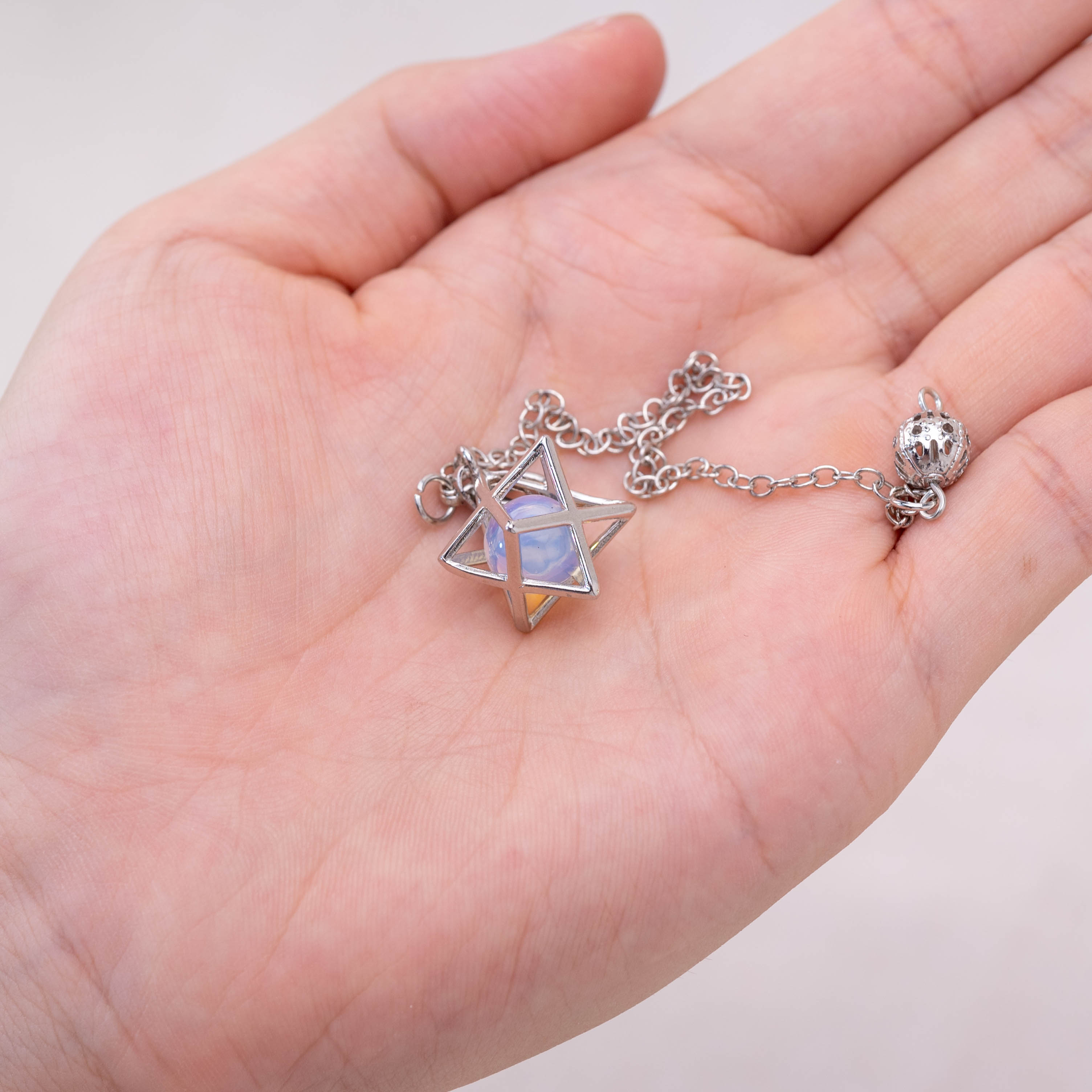 Opalite Merkaba pendulum enhancing tranquility