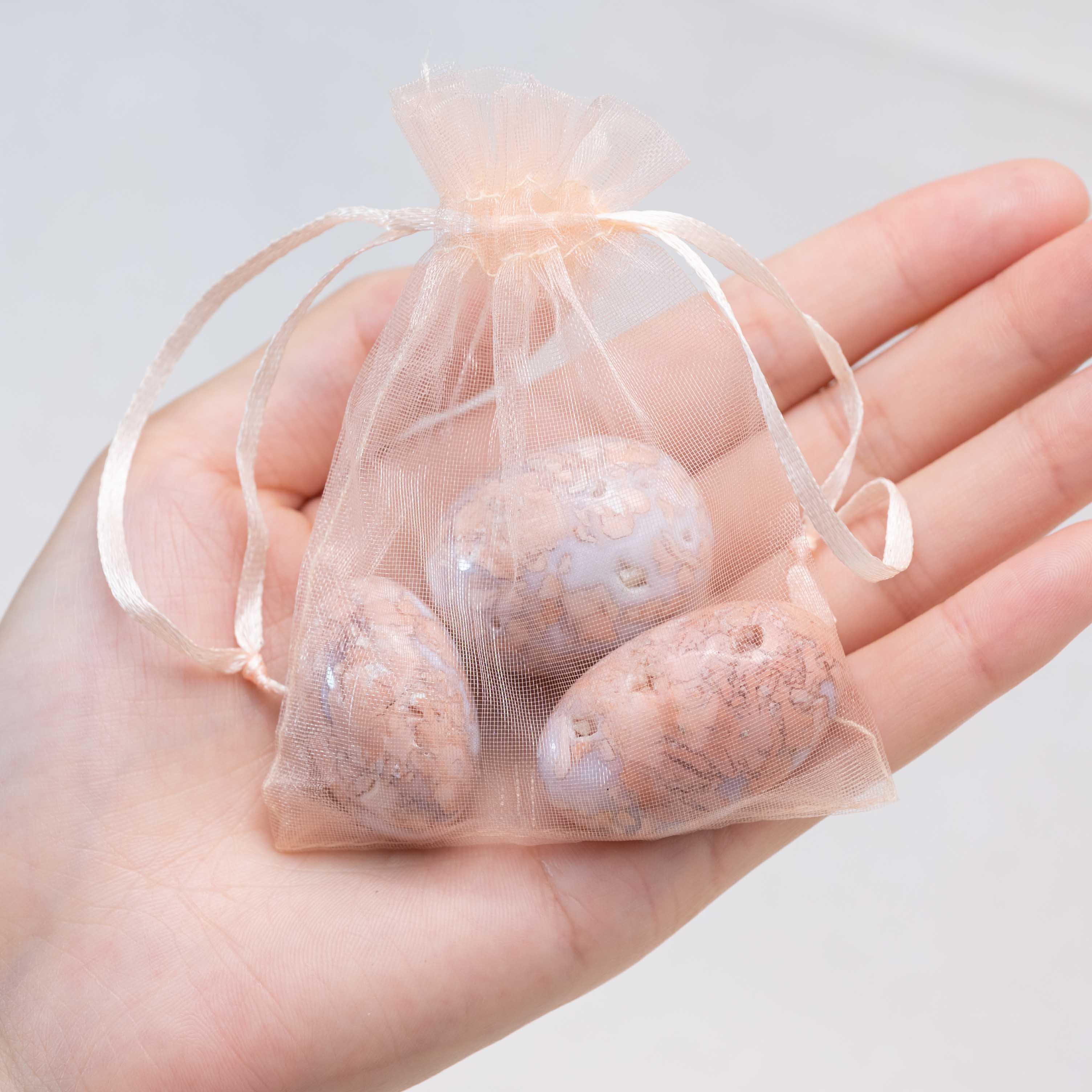 Detail shot of Petal Agate tumbled stone's unique patterns.