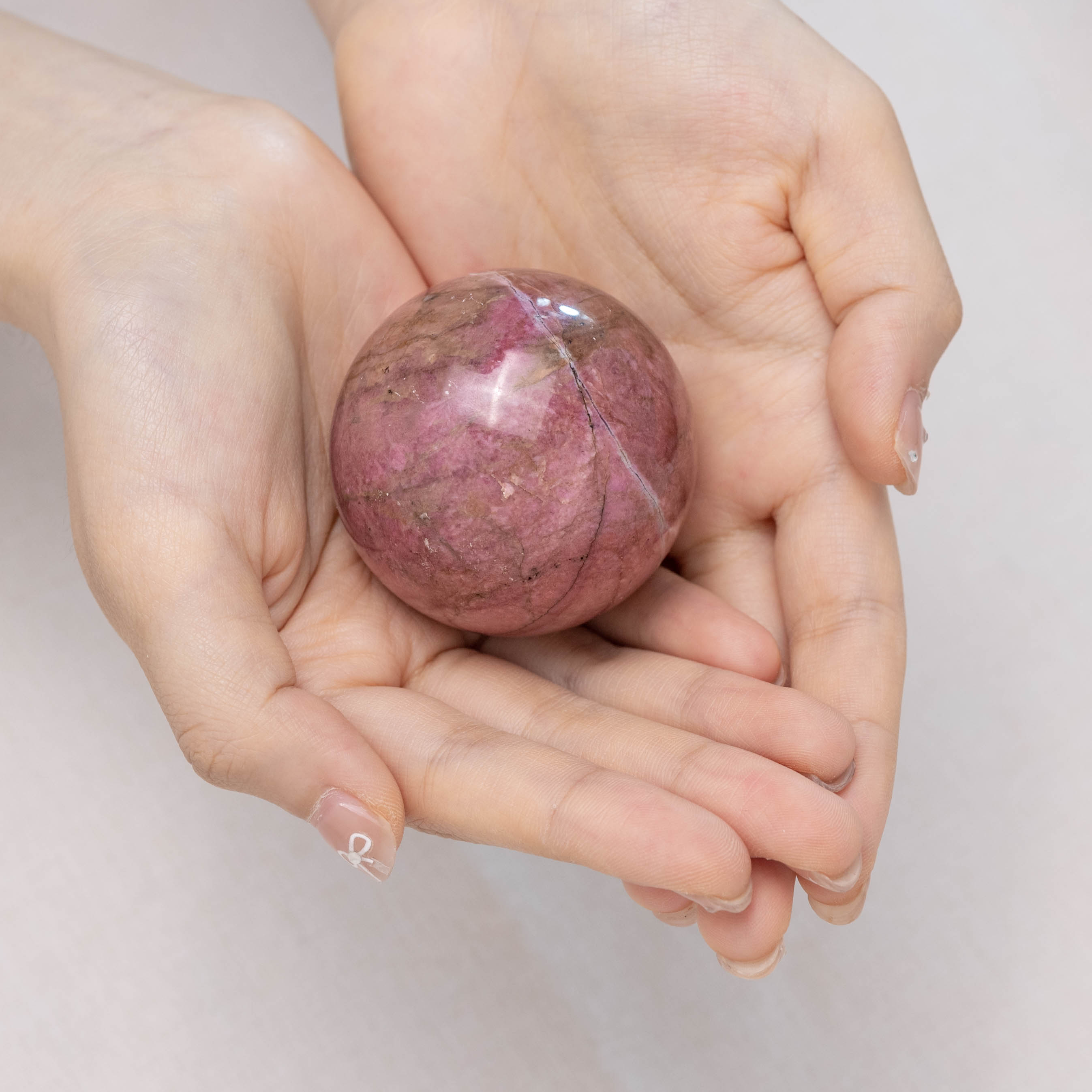 Hand-polished Pink Rhodonite Sphere for emotional healing
