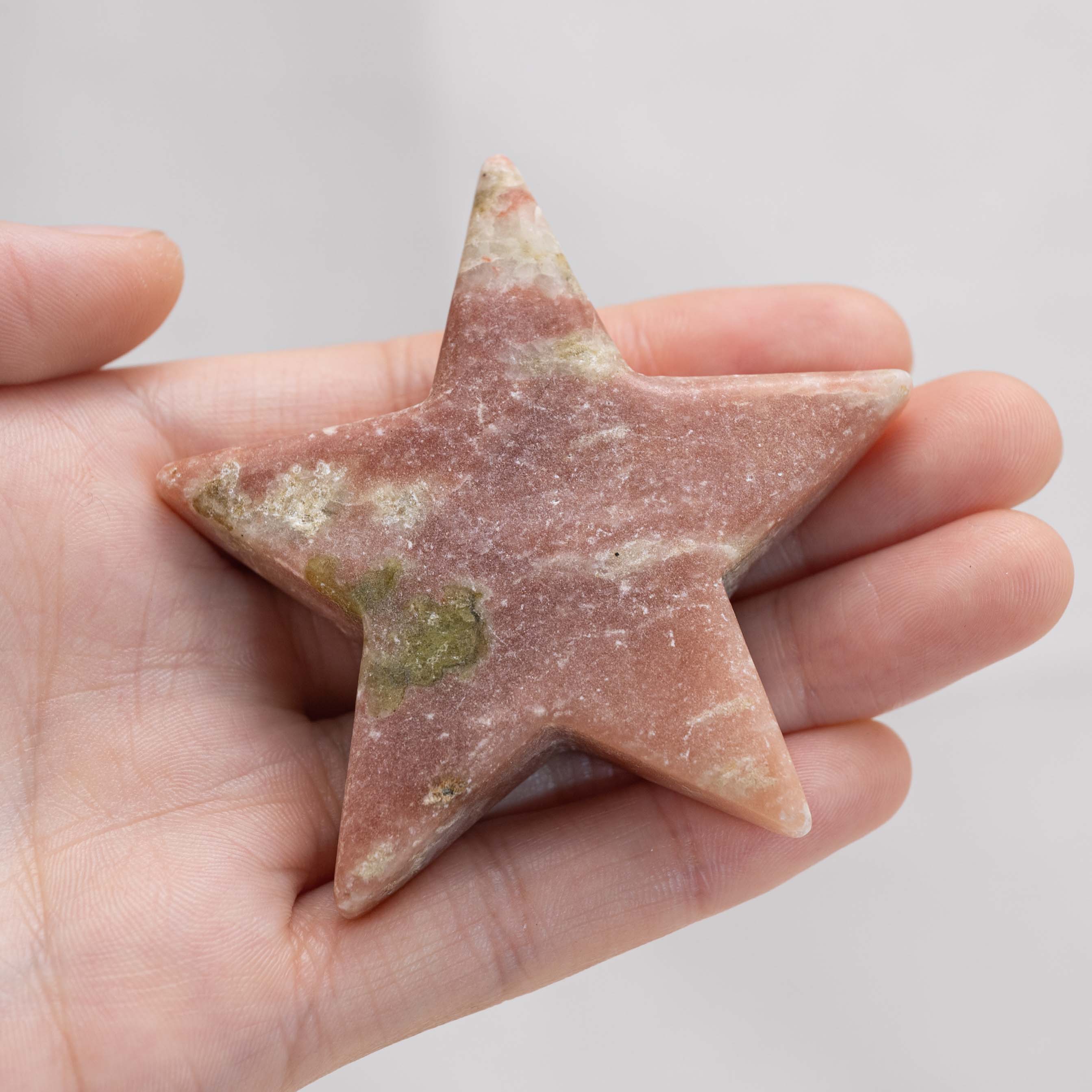 Detailed view of Pink Serpentine Star/Moon Palm Stone