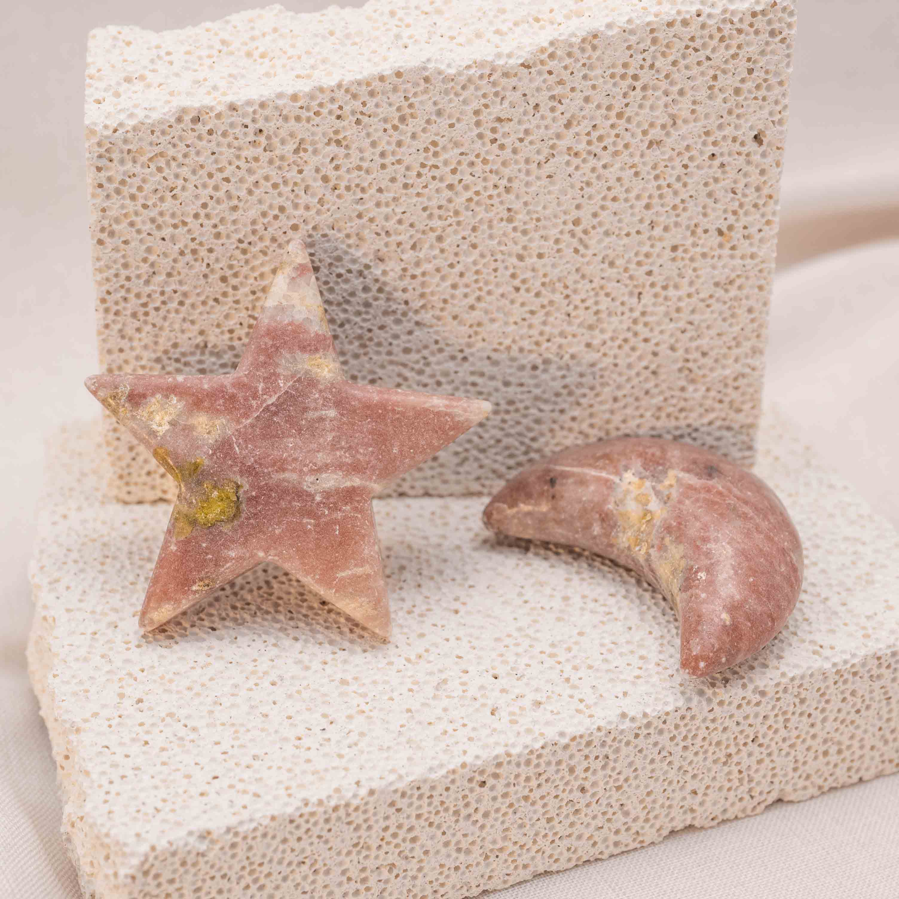 Hand holding Pink Serpentine Star/Moon Palm Stone