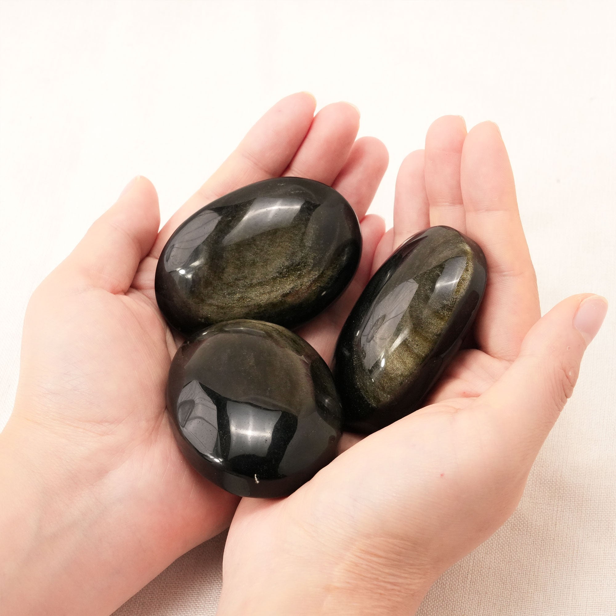 Polished Golden Obsidian Palm Stone promoting balance and harmony