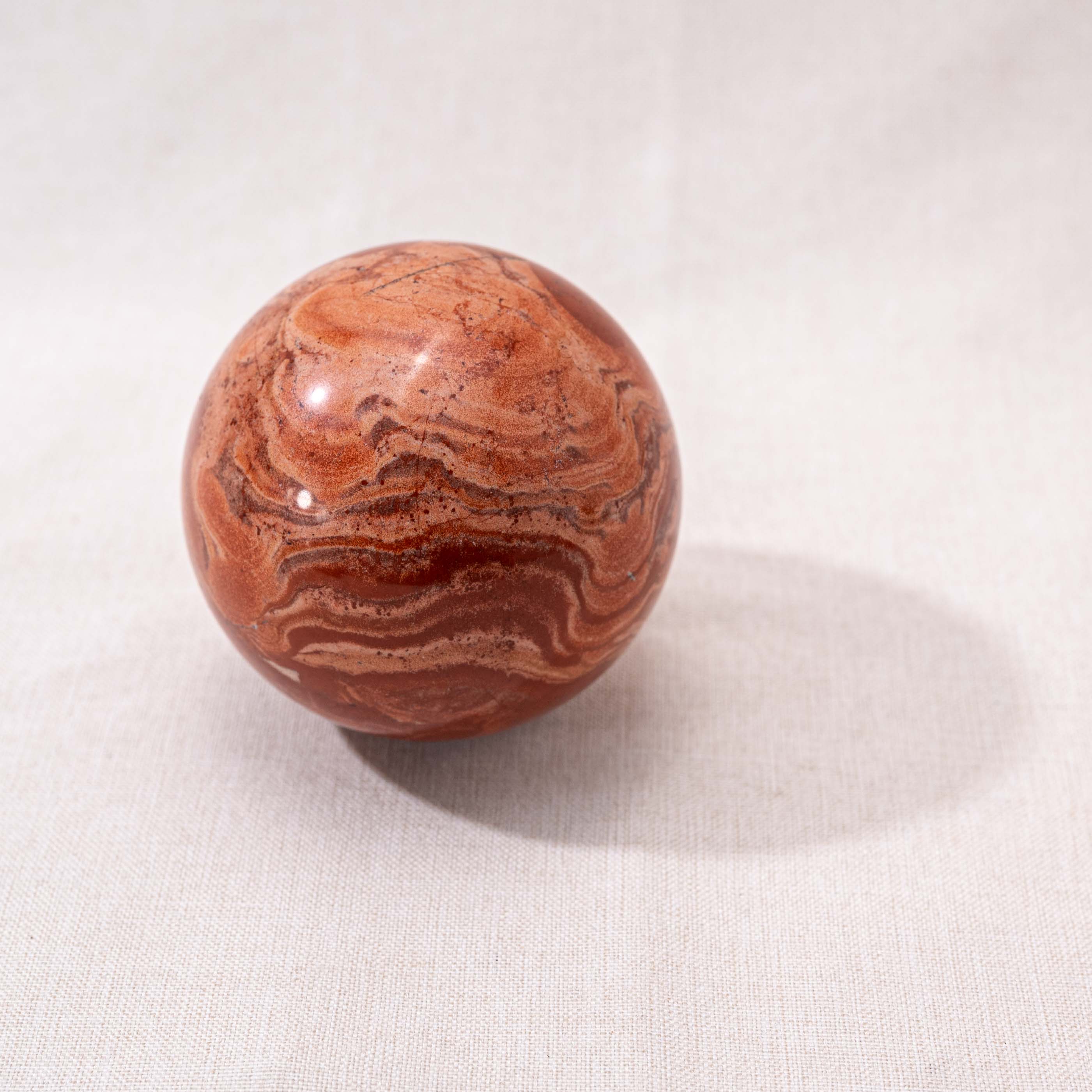 Vibrant Red Jasper Sphere promoting physical endurance and vitality.