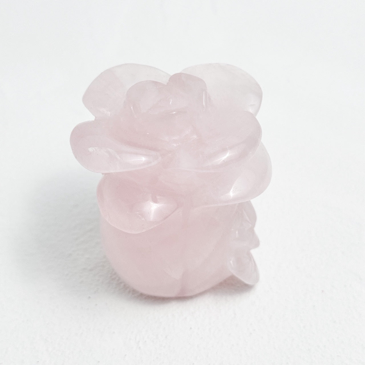 Delicate rose quartz carving of a rose in full bloom
