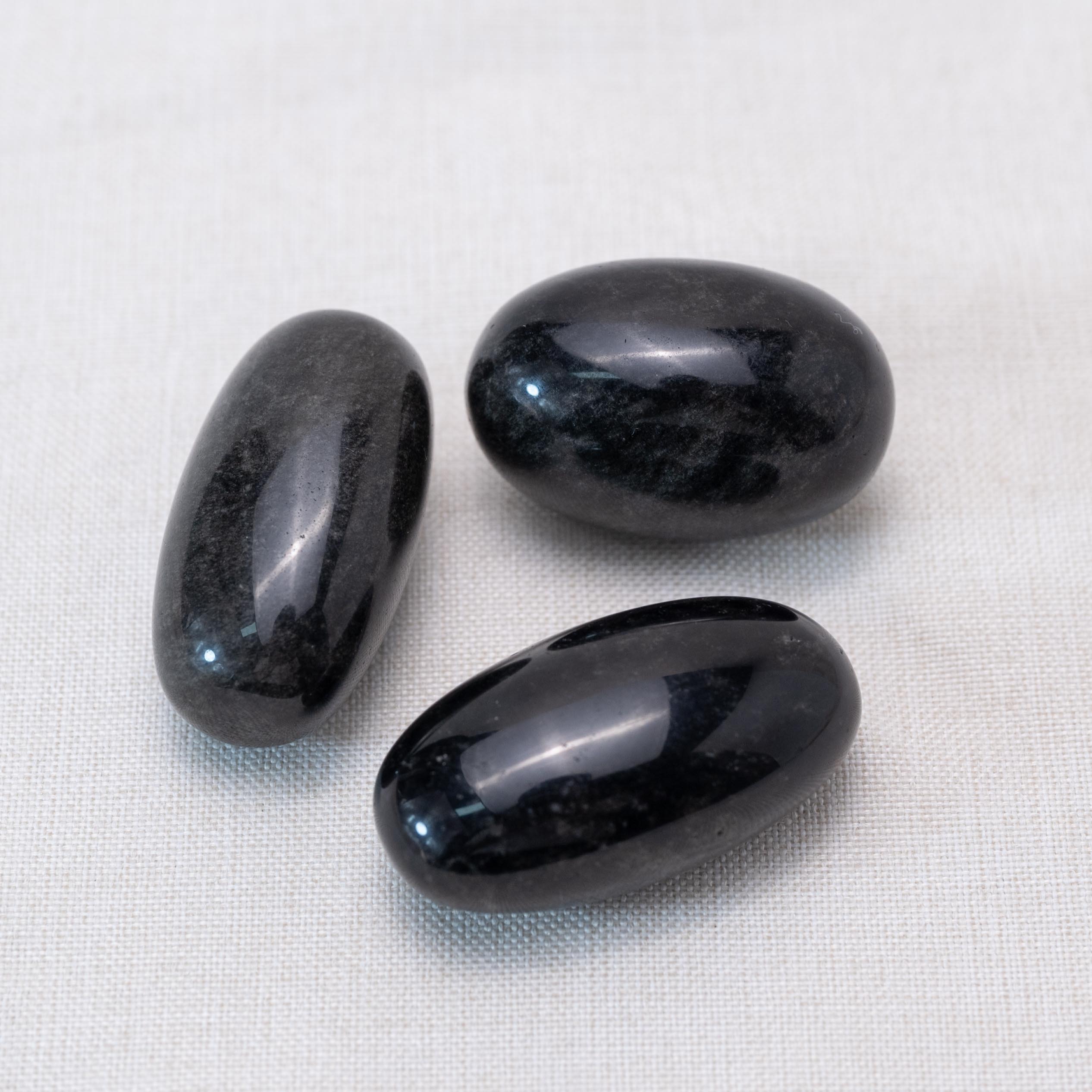 Displayed Silver Obsidian tumbled stones for reflective energy