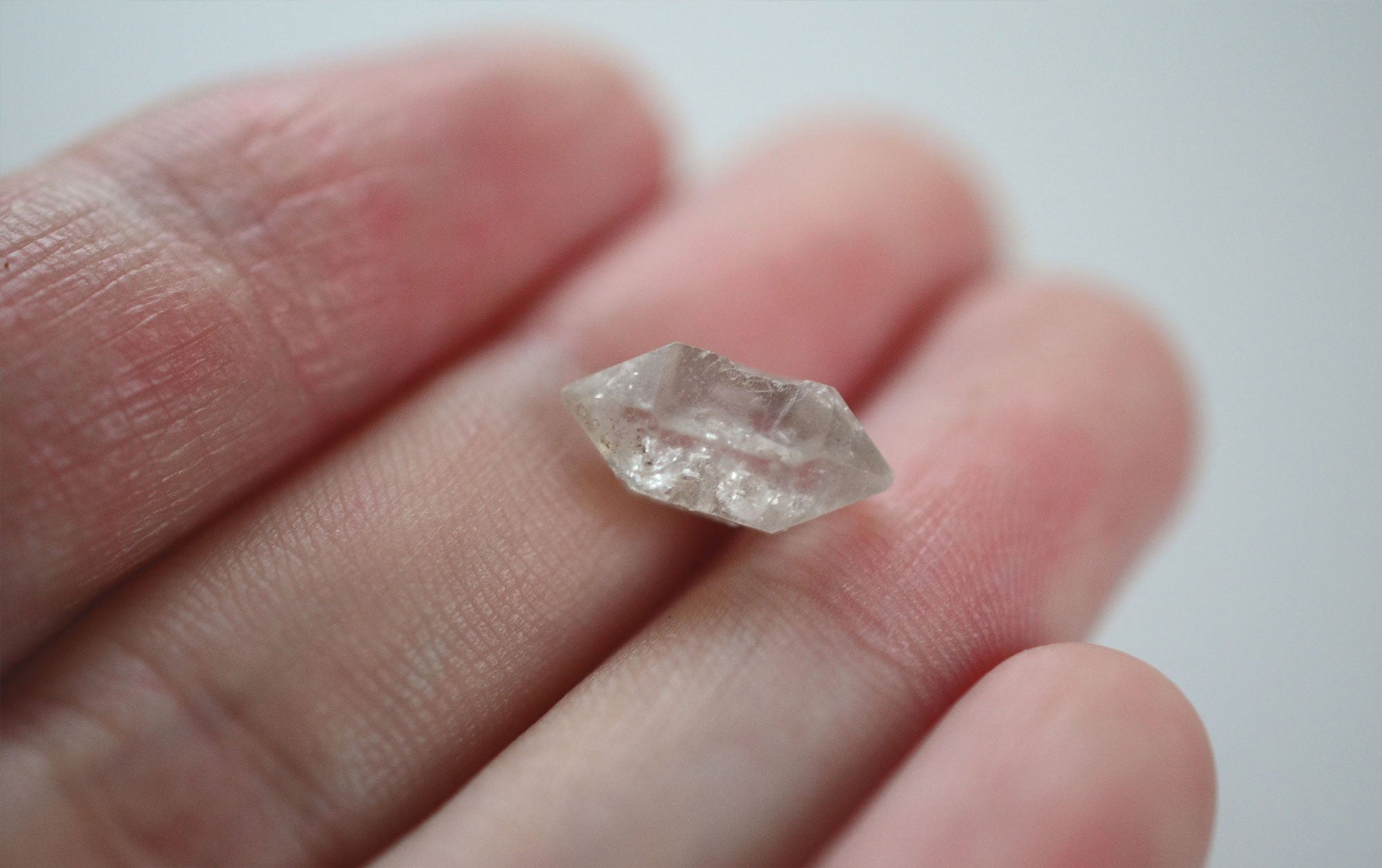 A clear Herkimer diamond crystal with a unique double-terminated structure and sparkling brilliance