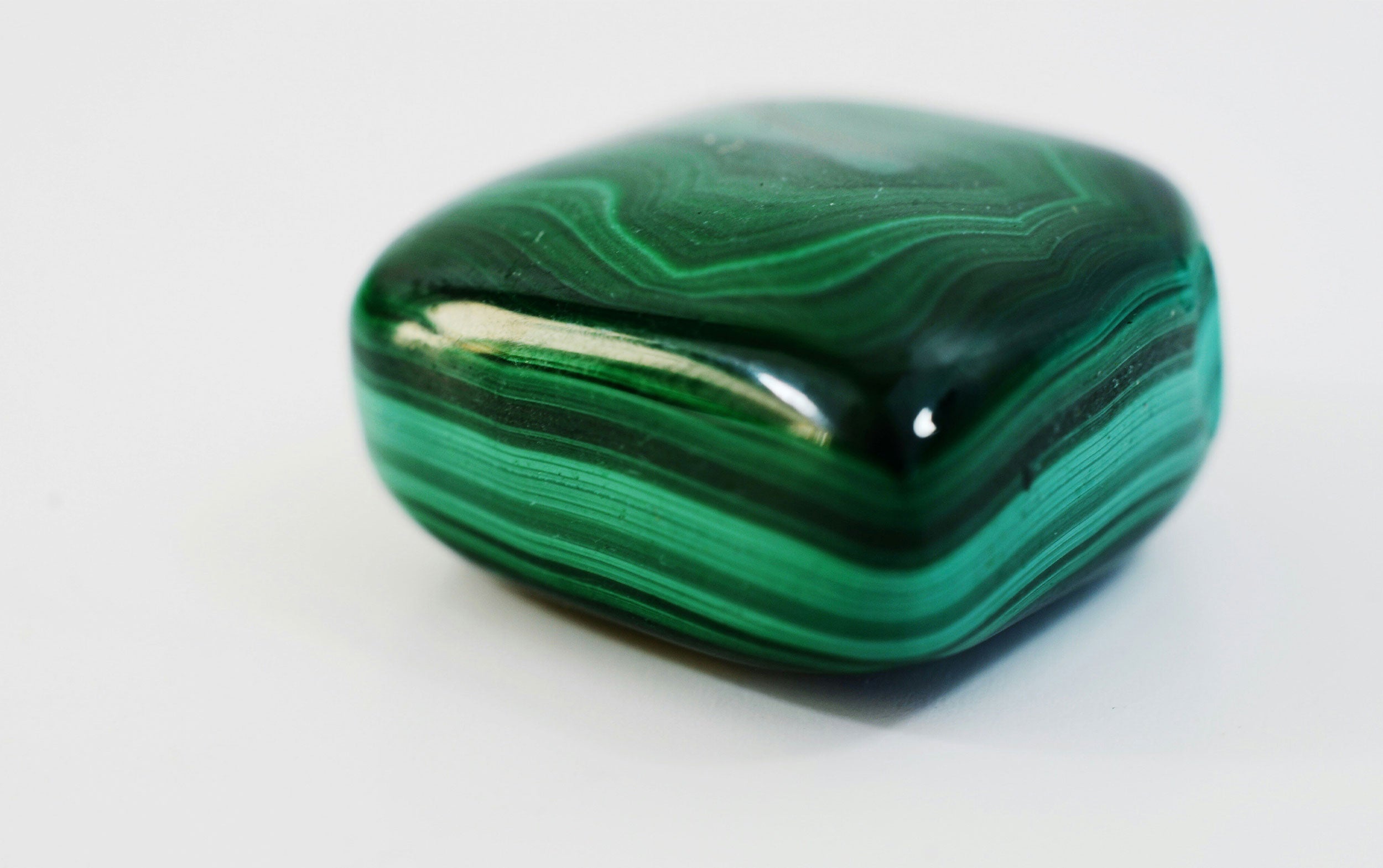 malachite stone displaying its unique green patterns and glossy surface