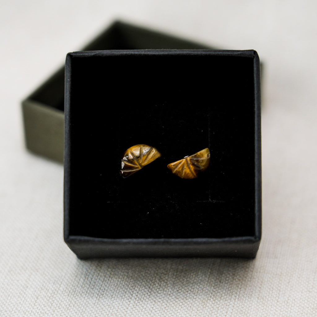 Modern and stylish tiger eye stone hoop earrings that highlight the stone's unique golden-brown hues.