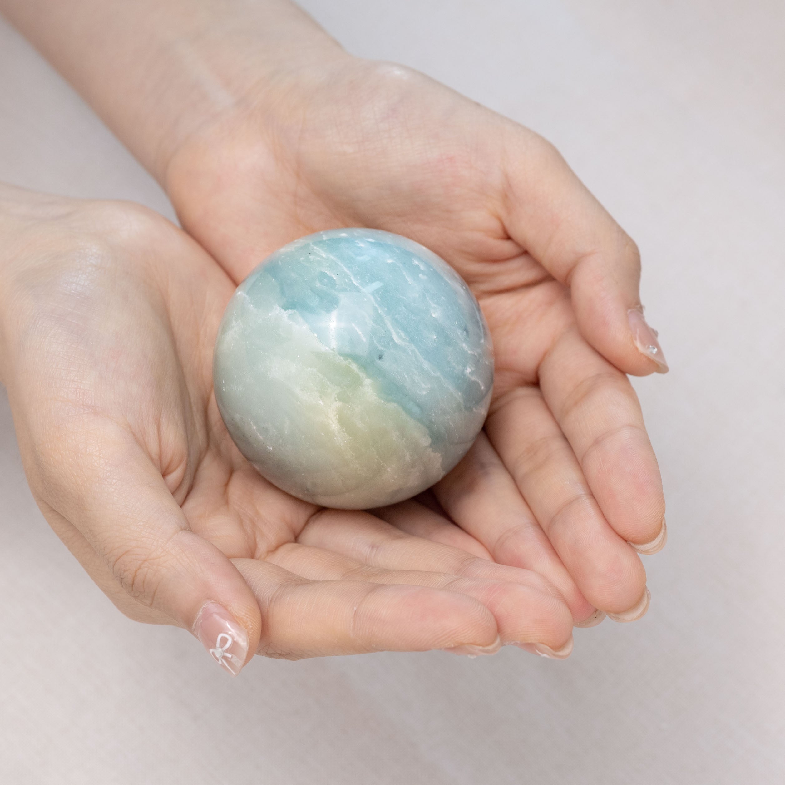 Natural amazonite sphere with unique patterns, ideal for meditation
