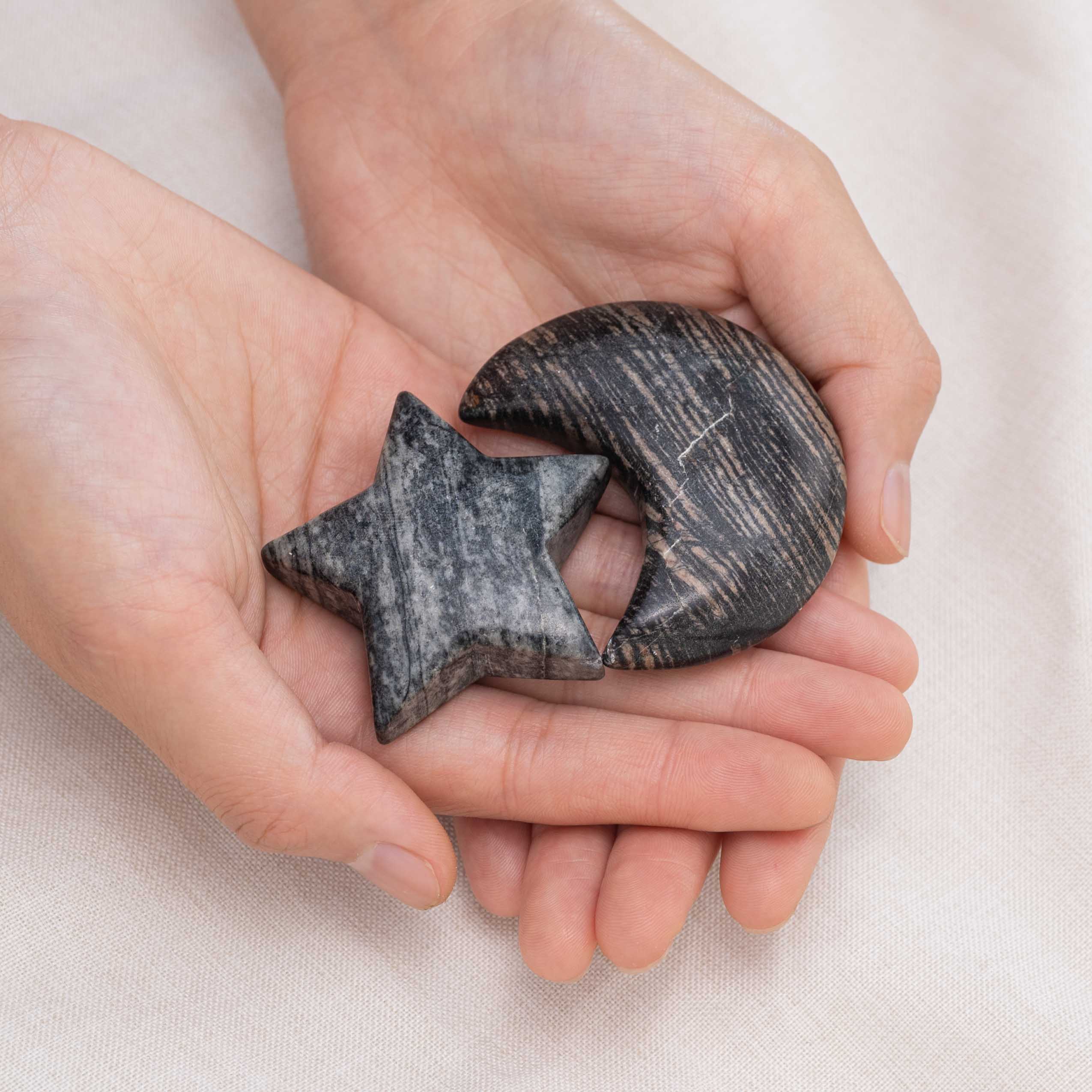 Black Net Stone Star/Moon Palm Stone held in hand