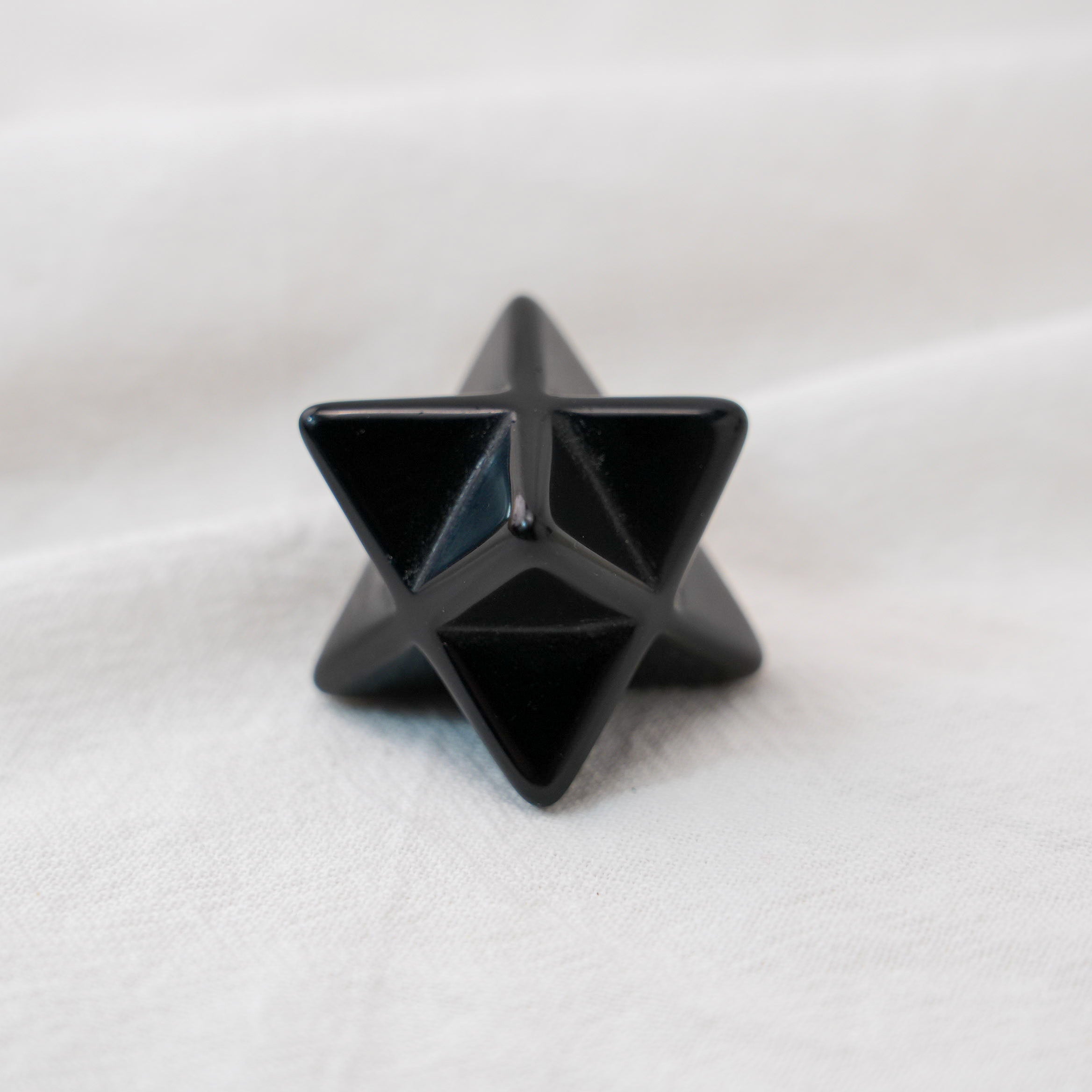 A powerful Black Obsidian Merkaba crystal star for energy protection and spiritual grounding