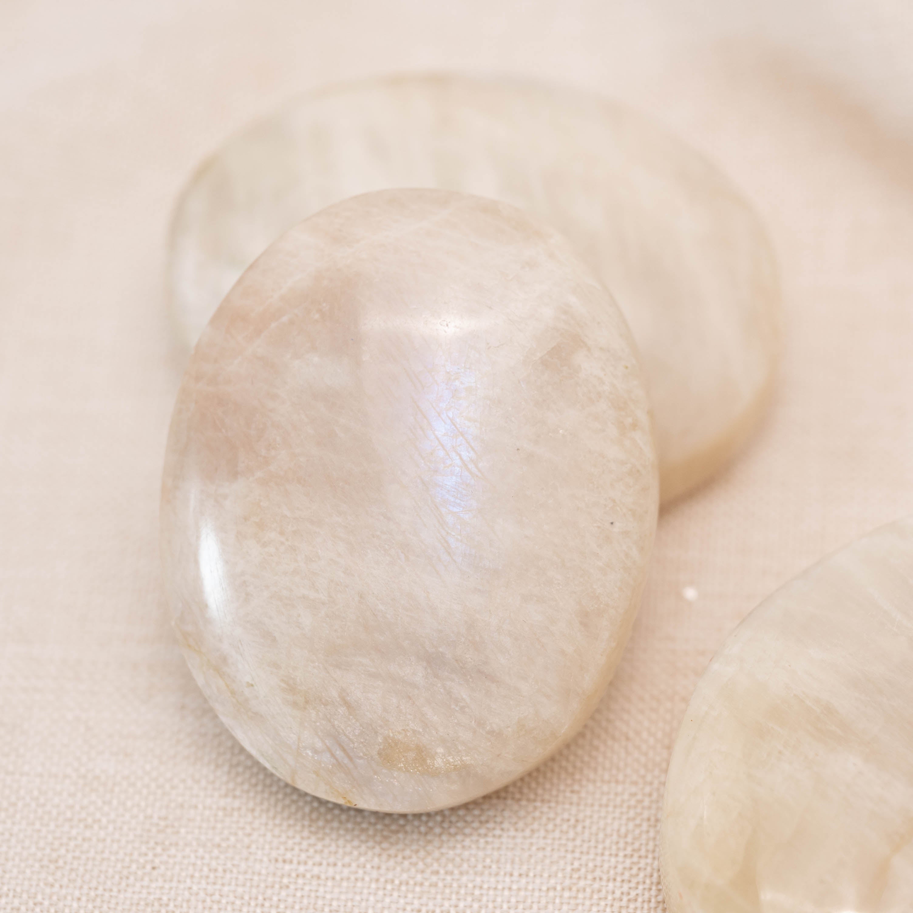 Polished Blue Moonstone Palmstone with calming blue sheen for stress relief