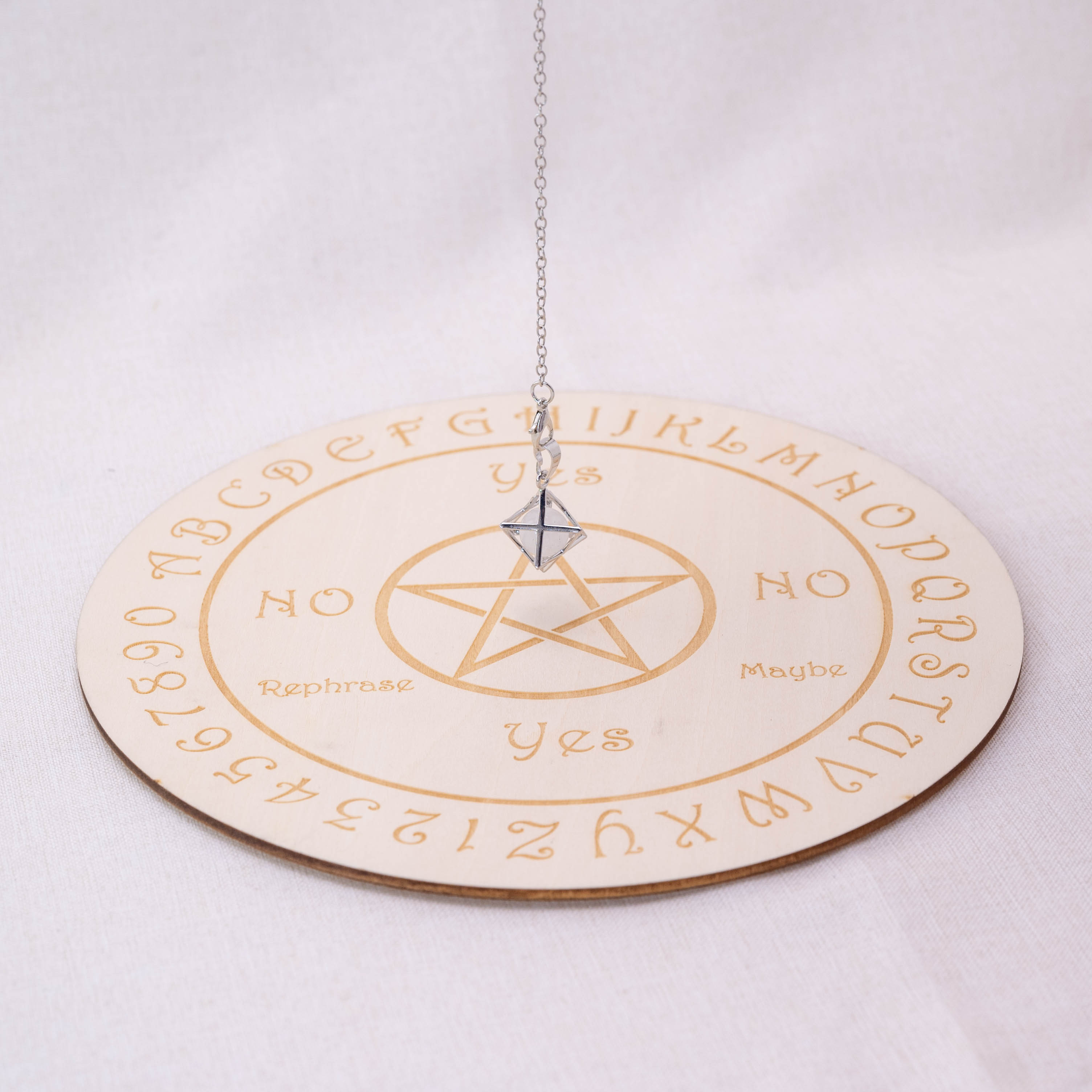 Detailed view of Clear Quartz Merkaba-shaped pendulum