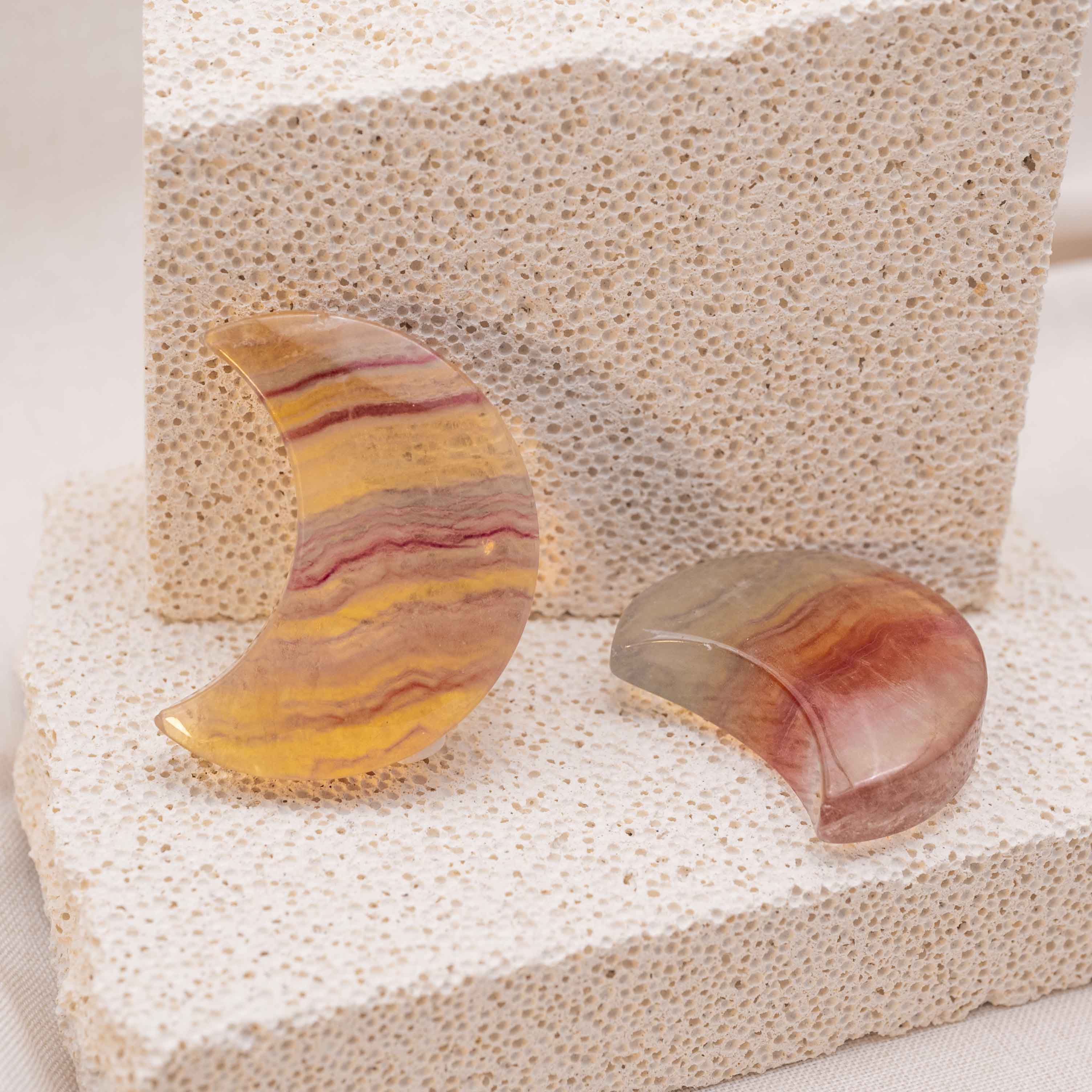 Display of Candy Fluorite Moon Palm Stone