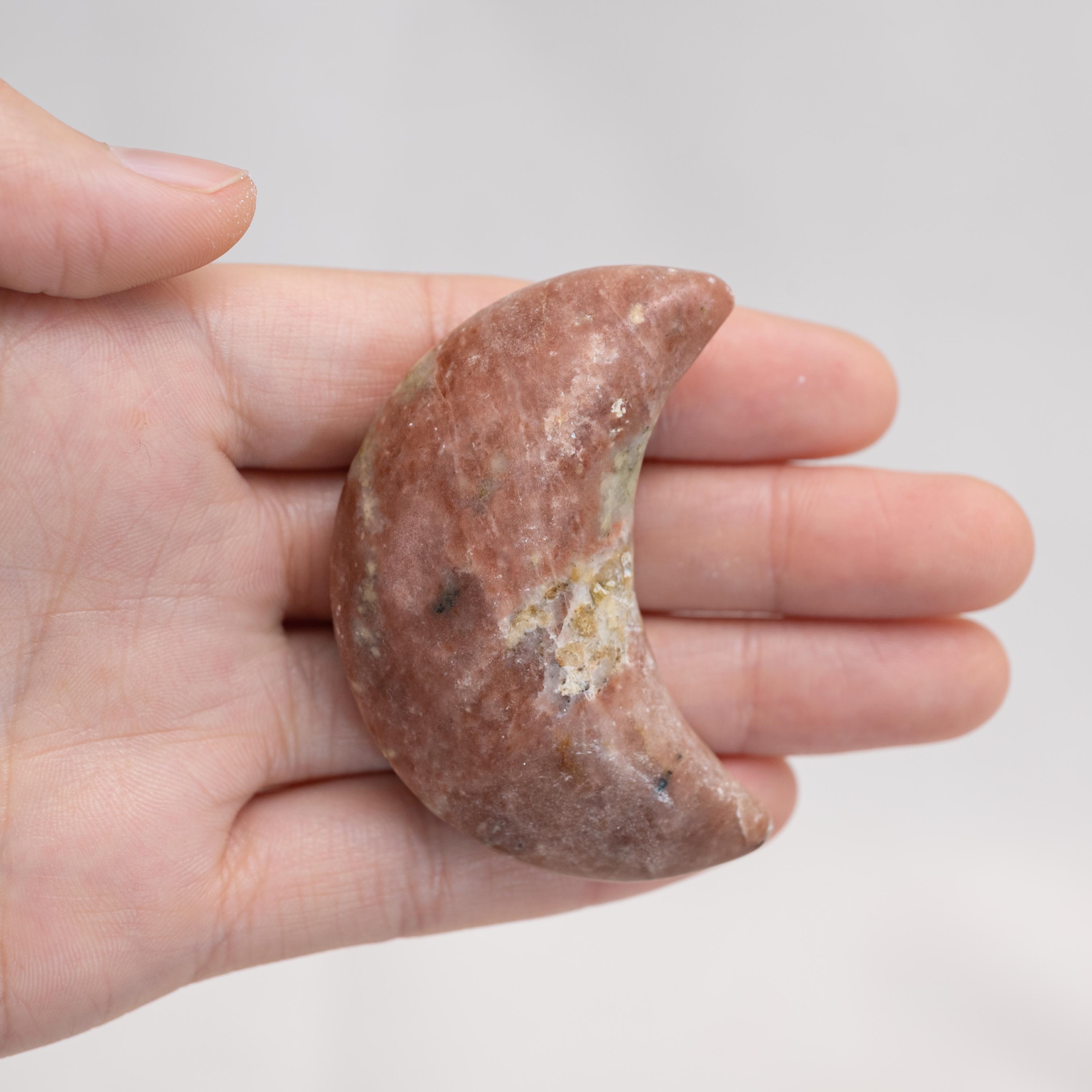 Close-up of Pink Serpentine Star/Moon Palm Stone