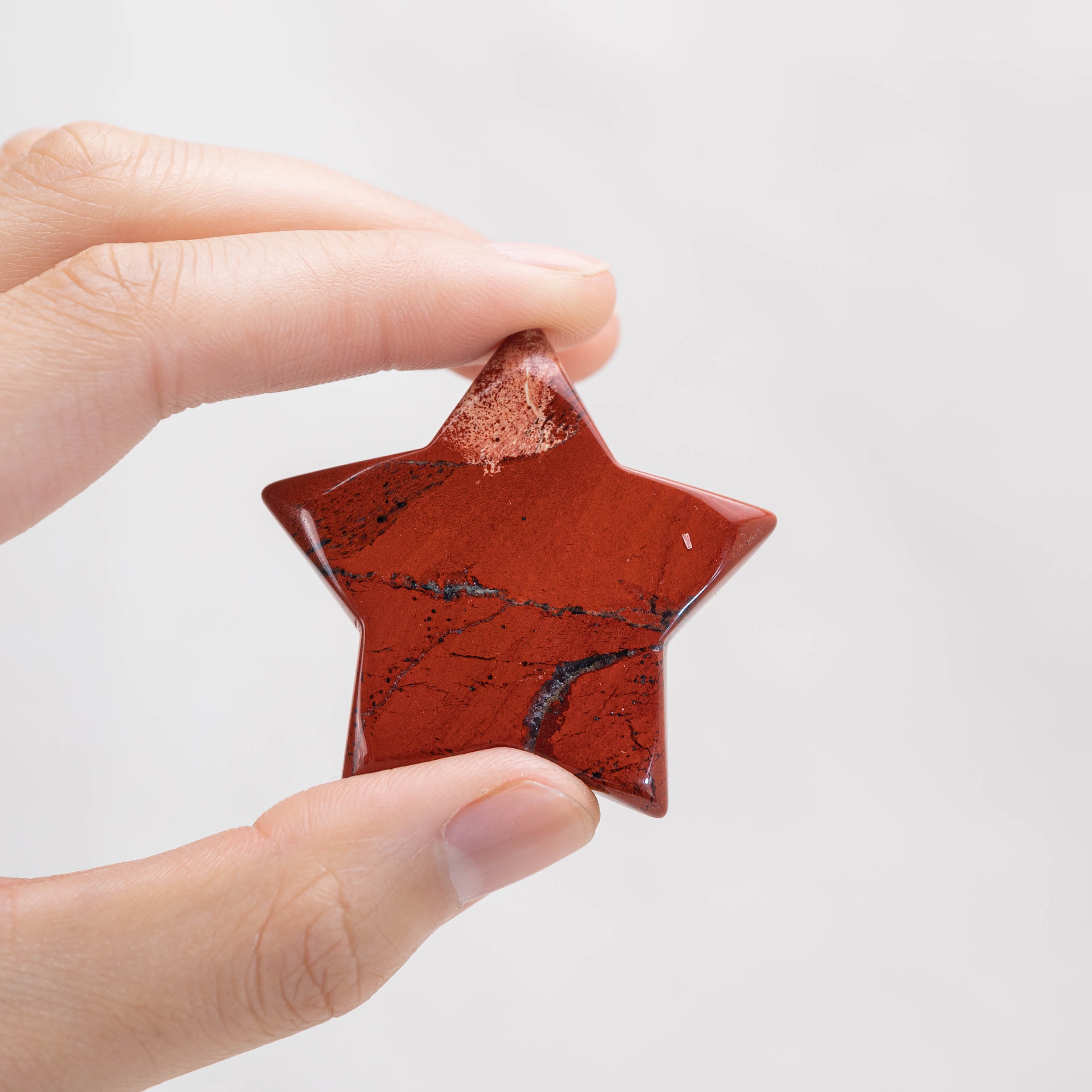 Detailed view of Red Jasper Star/Moon Palm Stone