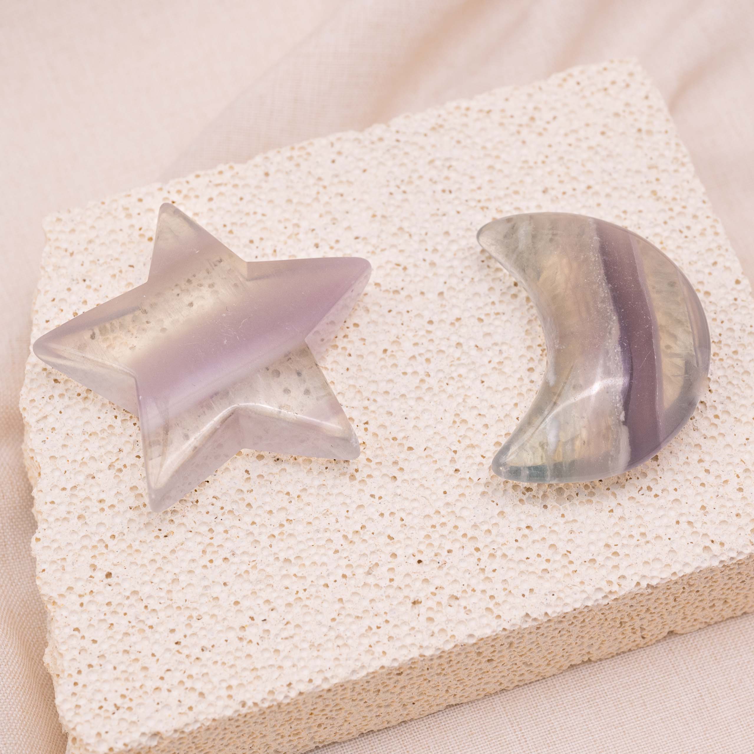 Light Purple Fluorite Star/Moon Palm Stone held in hand