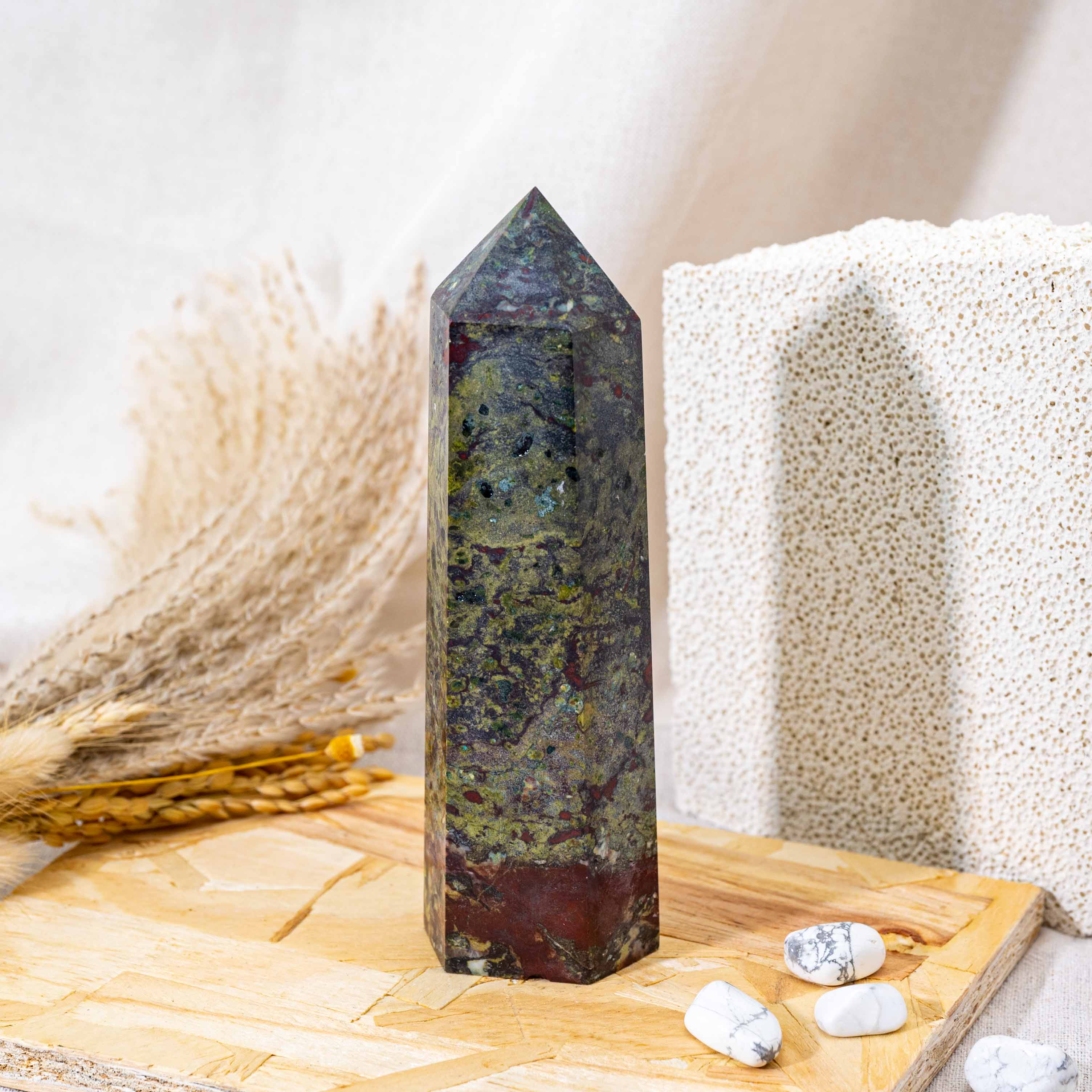 The Dragon Blood Stone Tower is a powerful healing crystal known for its vibrant green and red hues, promoting physical vitality and emotional balance