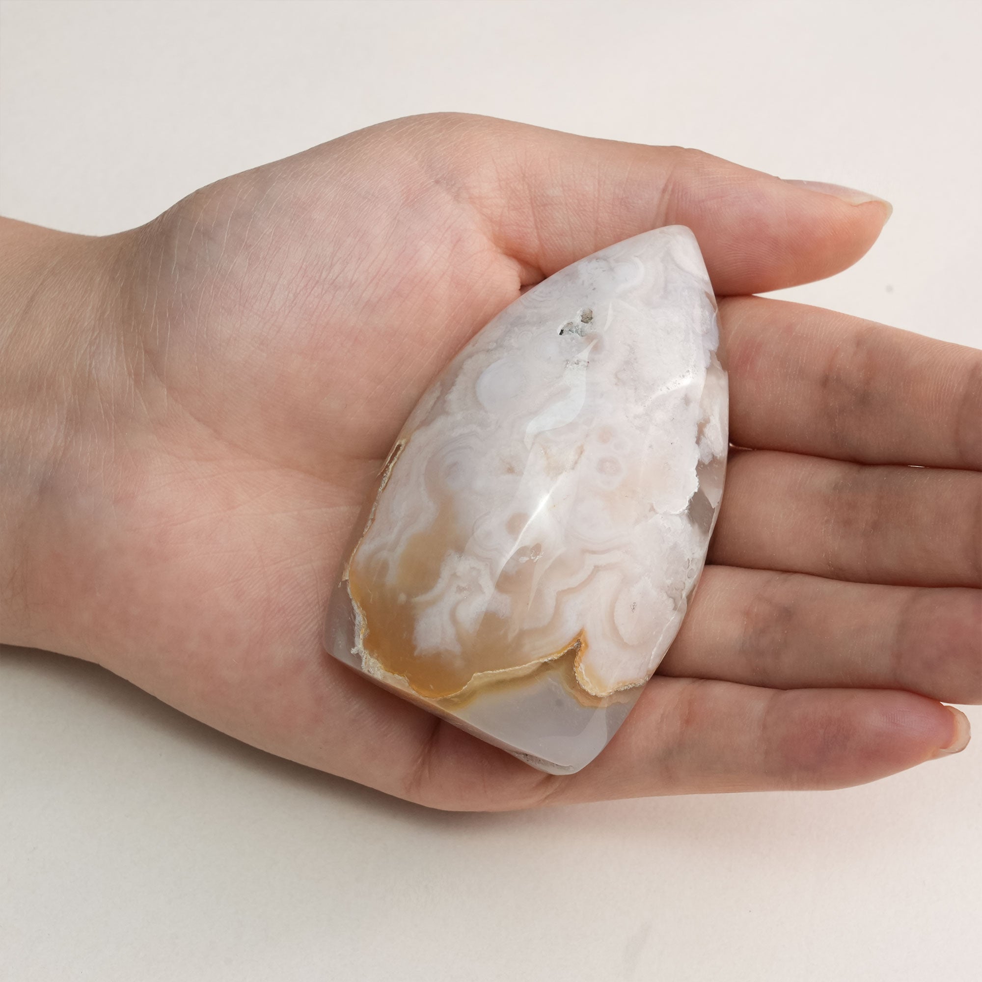Close-up of a polished Flower Agate stone, revealing its natural beauty