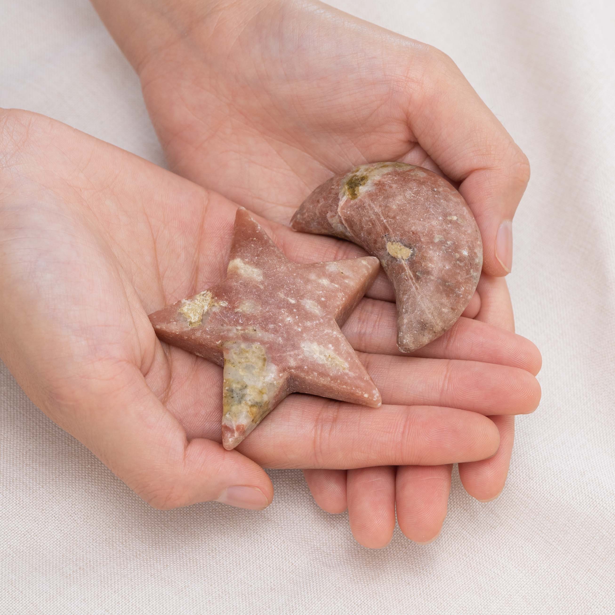 Pink Serpentine Star/Moon Palm Stone held in hand