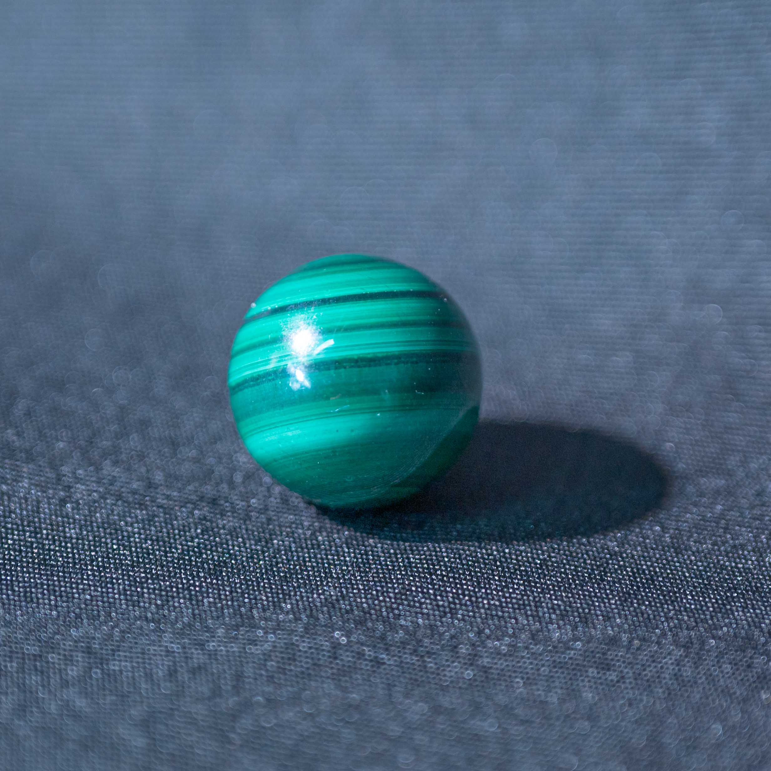 This Malachite Mini Sphere promotes healing and emotional balance with its vibrant green hues.