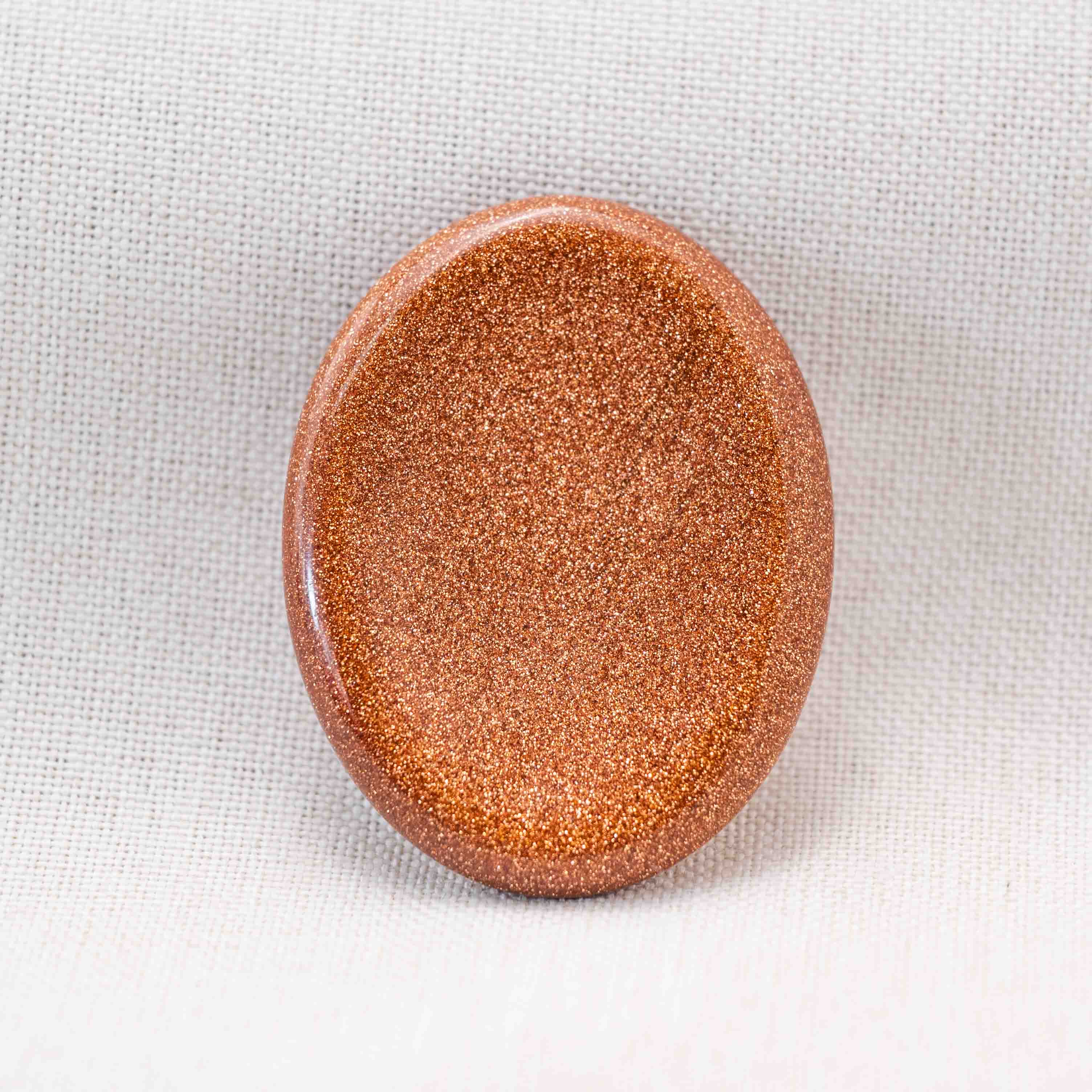 The Gold Sand Worry Stone enhances creativity and attracts positive energy