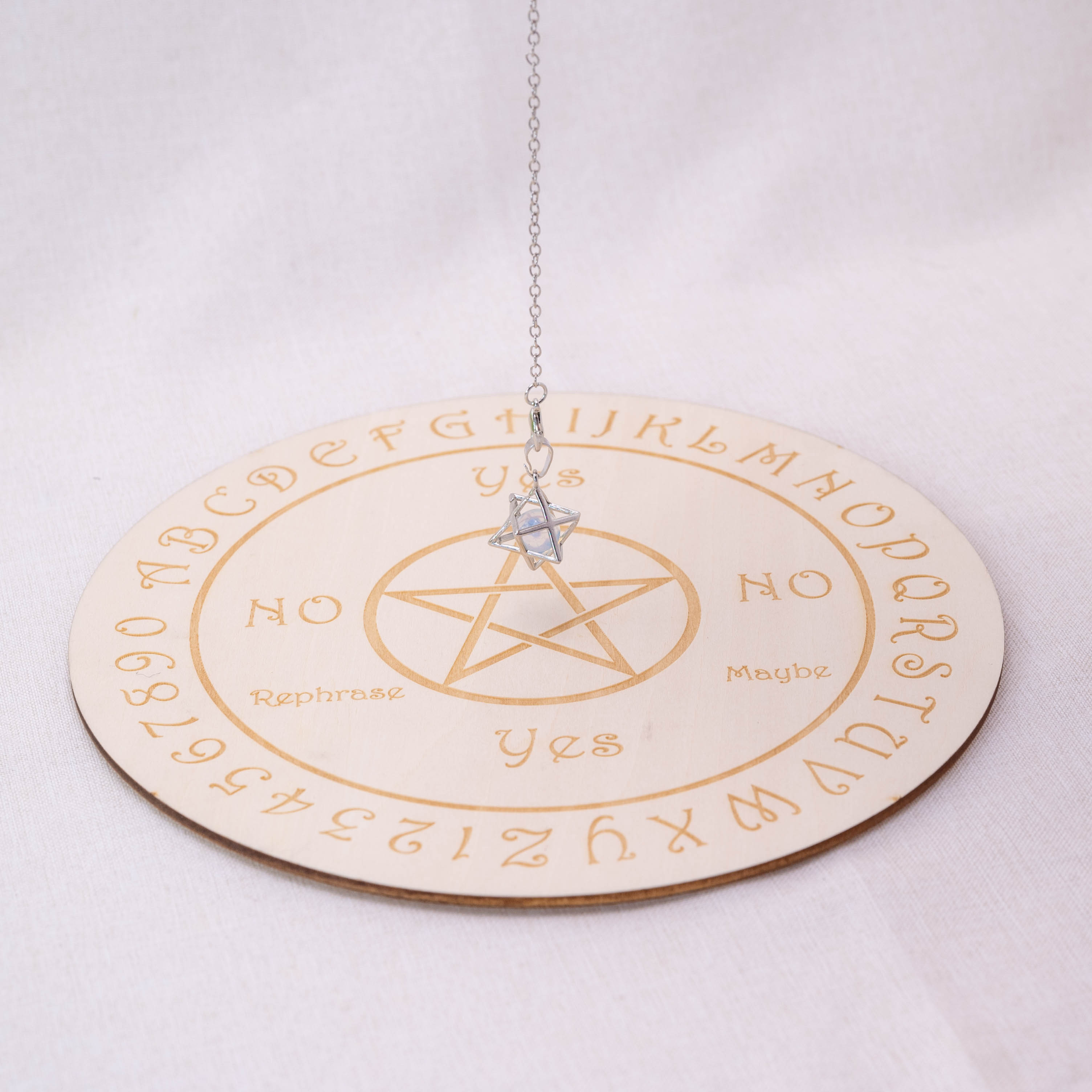 Detailed view of Opalite Merkaba-shaped pendulum