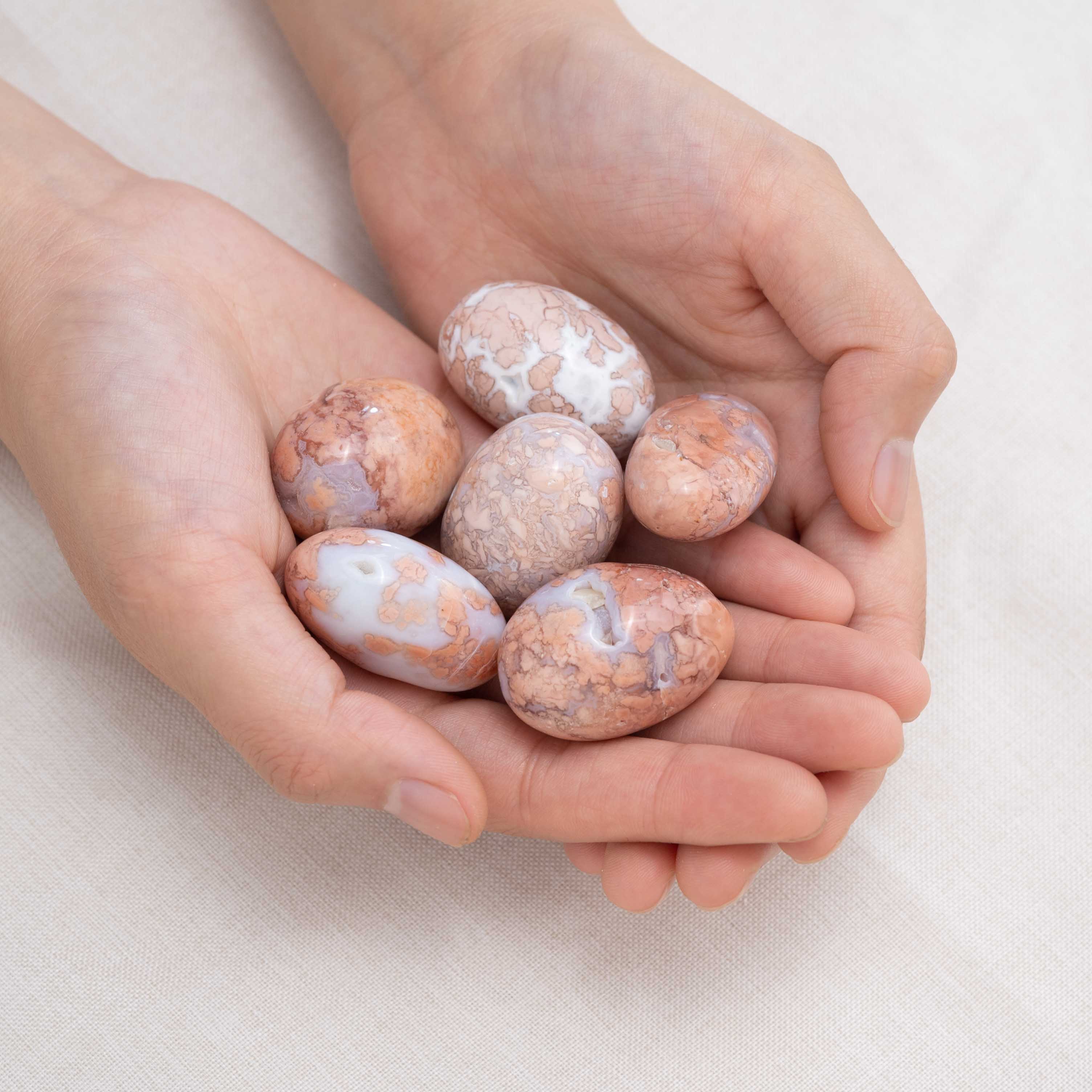 Hand cupping Petal Agate tumbled stone for nurturing energy